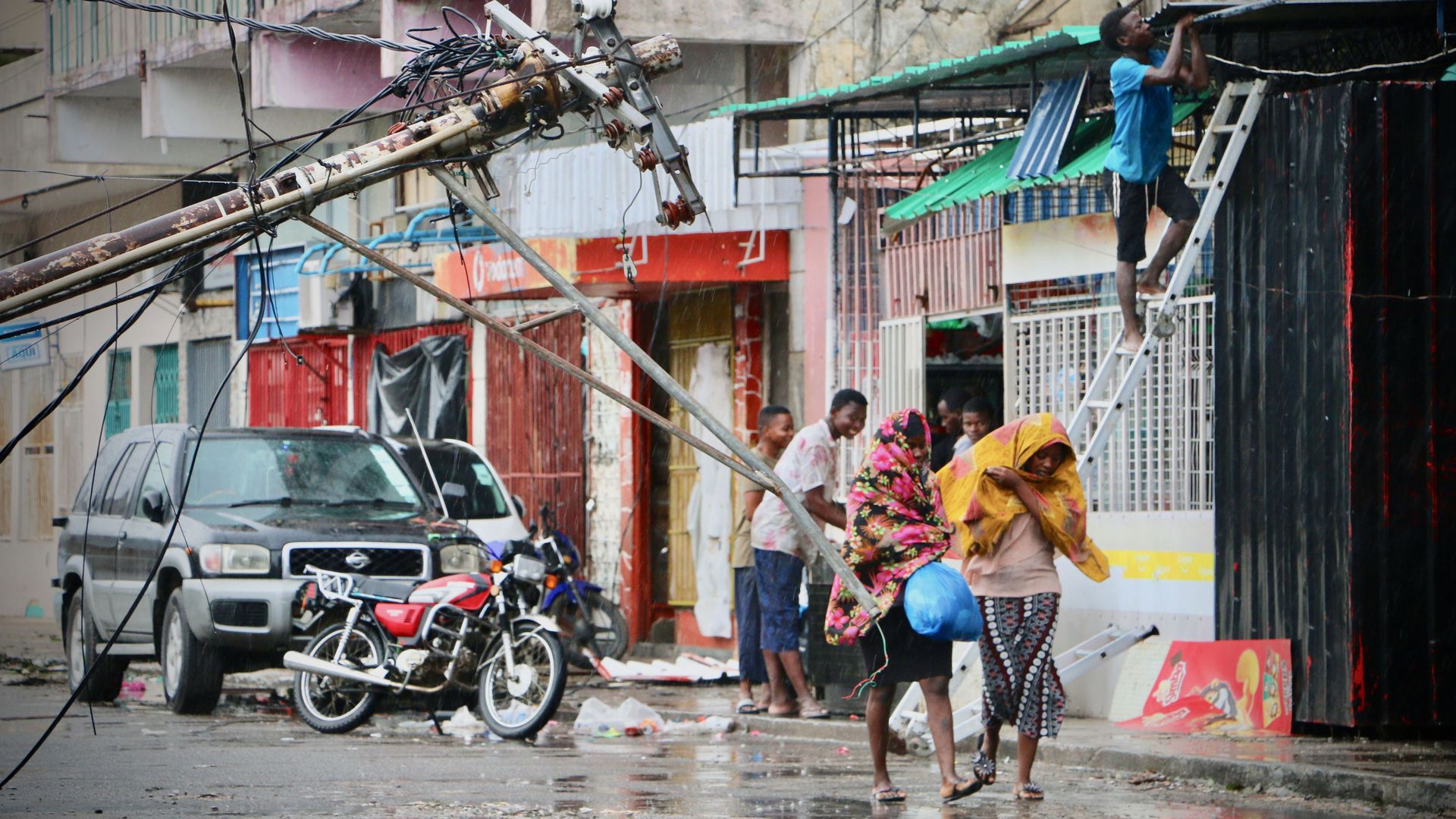 Residents in Mozambique try to protect themselves while finding shelter