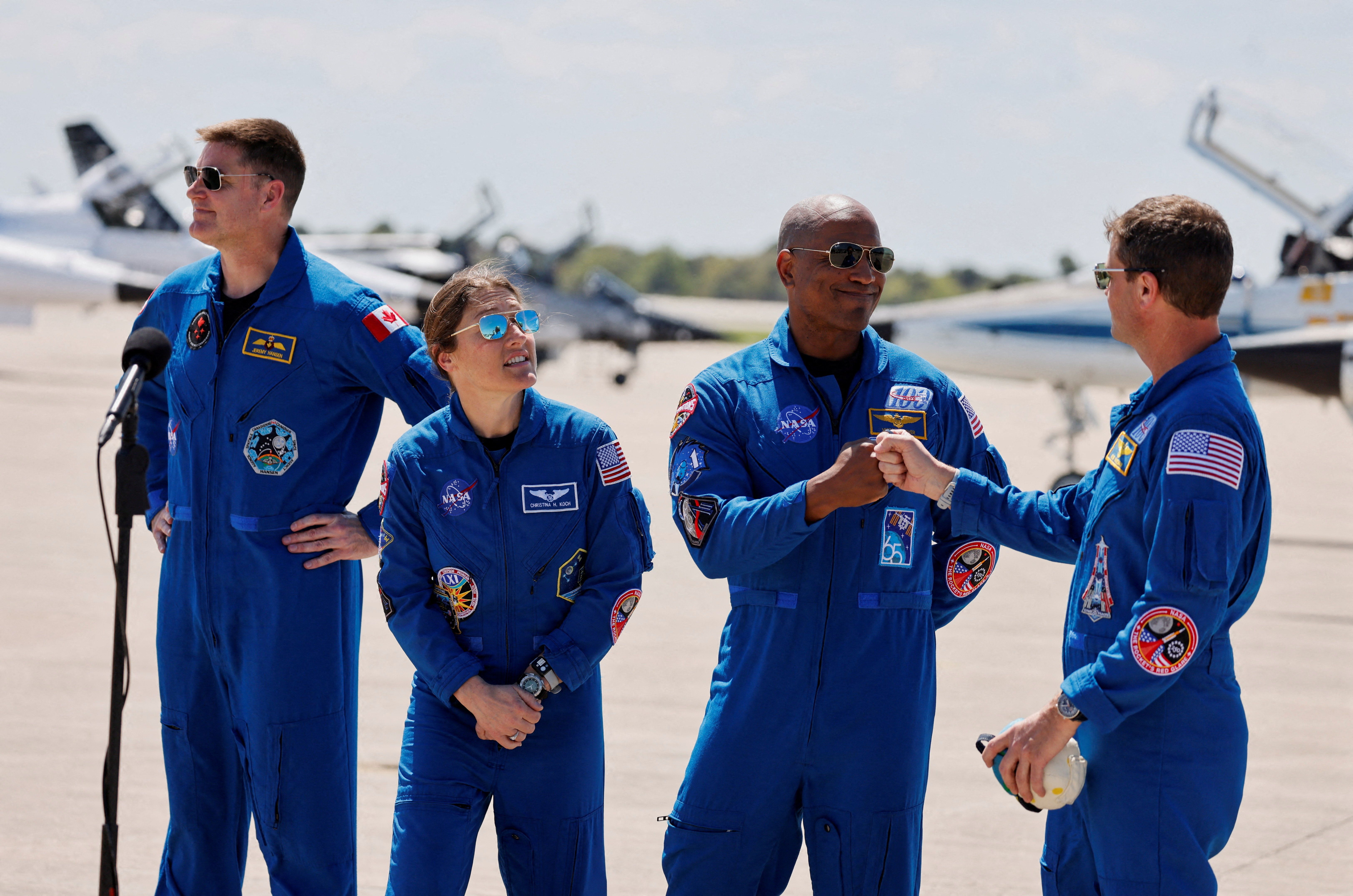 NASA astronauts Reid Wiseman and Victor Glover greet each other next to NASA astronaut Christina Koch and CSA (Canadian Space Agency) astronaut Jeremy Hansen, at Kennedy Space Centre, ahead of the Artemis II launch in Cape Canaveral, Florida, U.S., March 27, 2026. REUTERS/Joe Skipper 