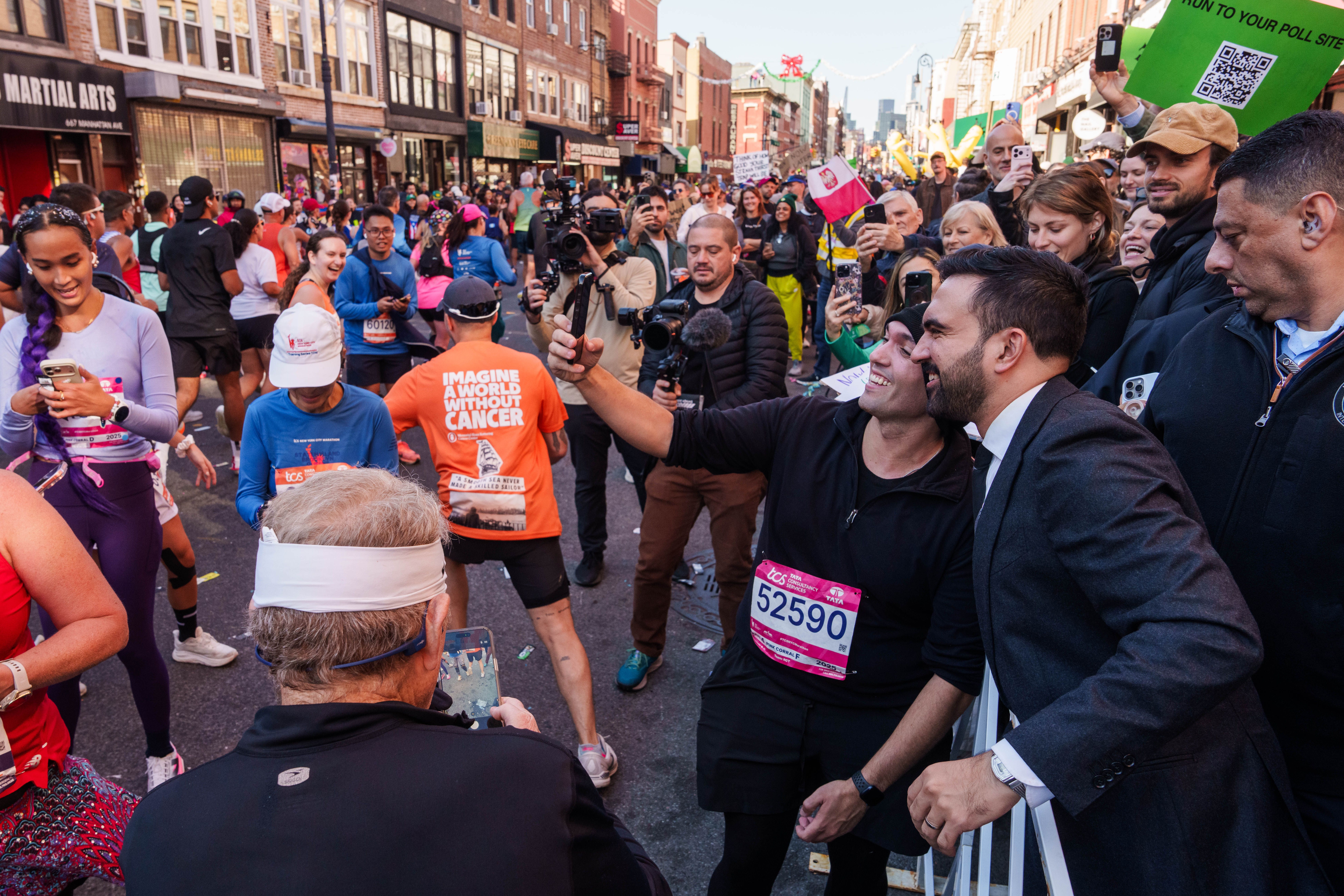 Marathon runners pull over to take selfies with mayoral candidate Zohran Mamdani near the halfway mark in Brooklyn. 