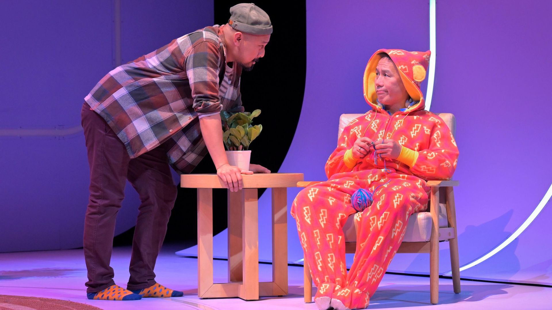 two people on stage, one in a snuggie