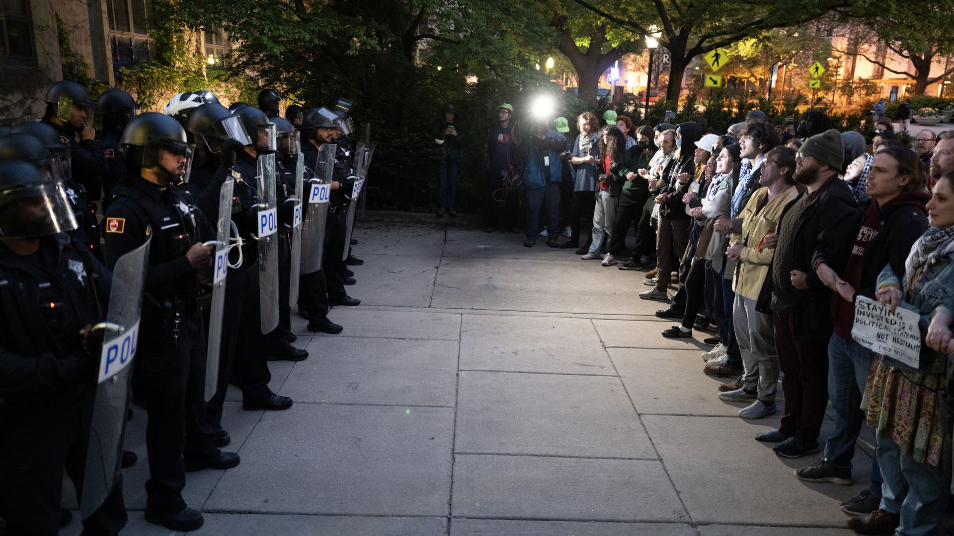 Photo of a line of police next to a line of protesters