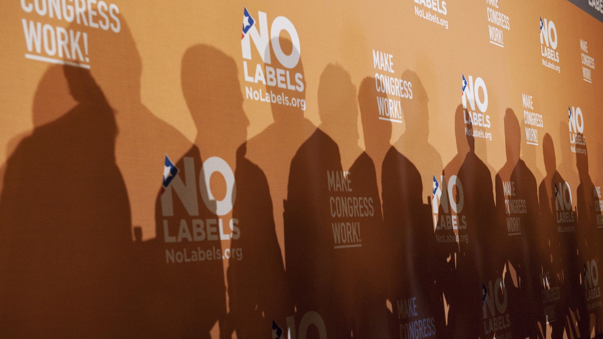 Shadows of a group of people against an orange wall covered with repeated white text reading "NO LABELS NoLabels.org" and "MAKE CONGRESS WORK!" logos.