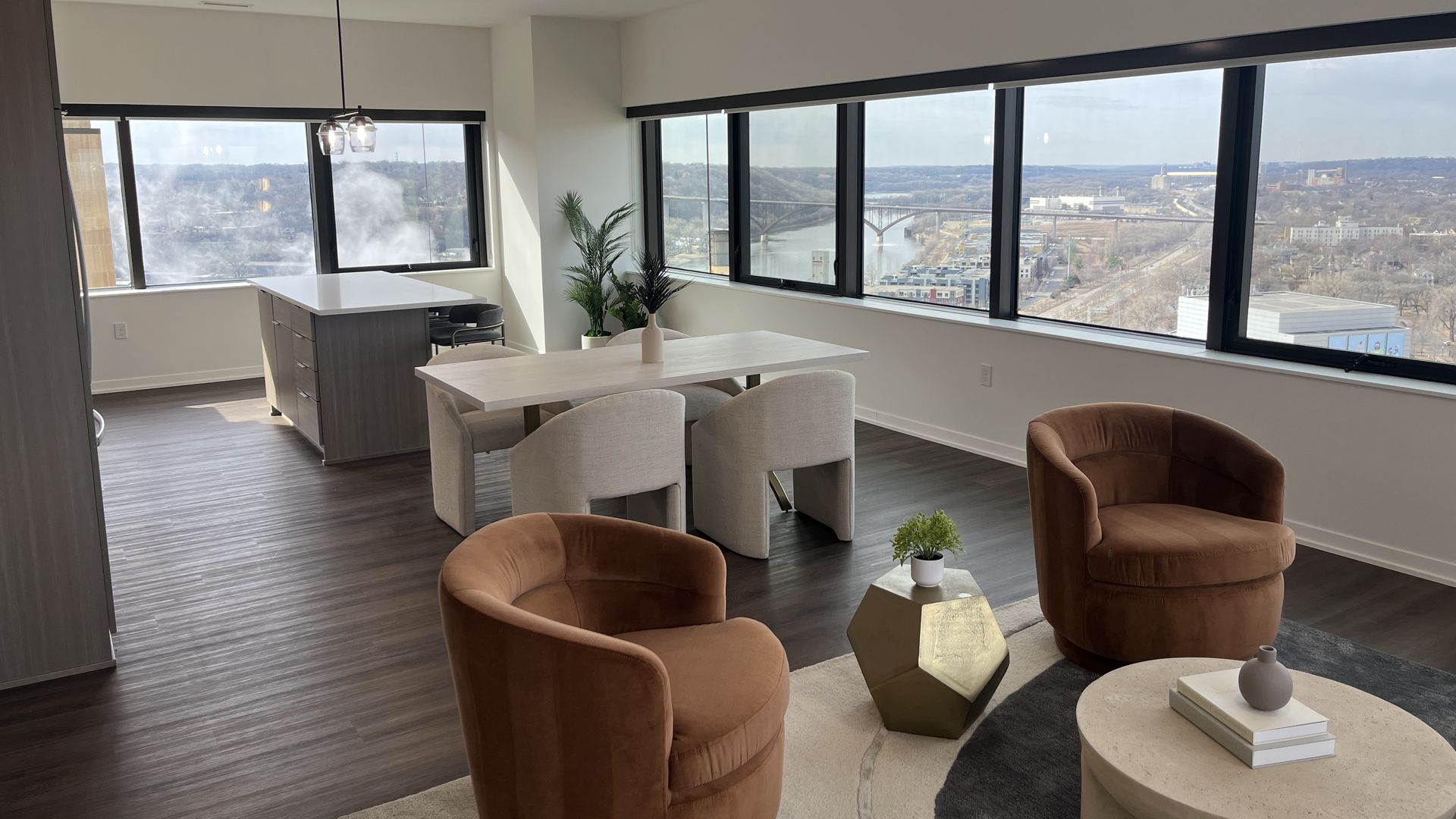 A photo of a living room in an apartment with the river in the background
