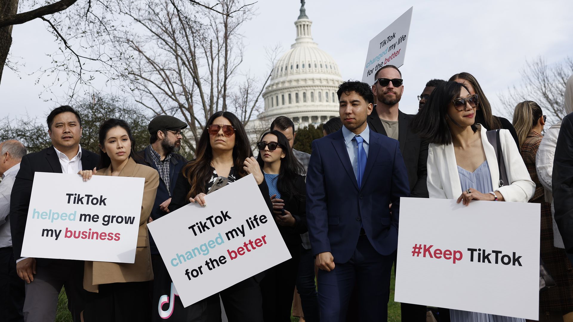 Participants hold signs in support of TikTok outside the U.S. Capitol Building 