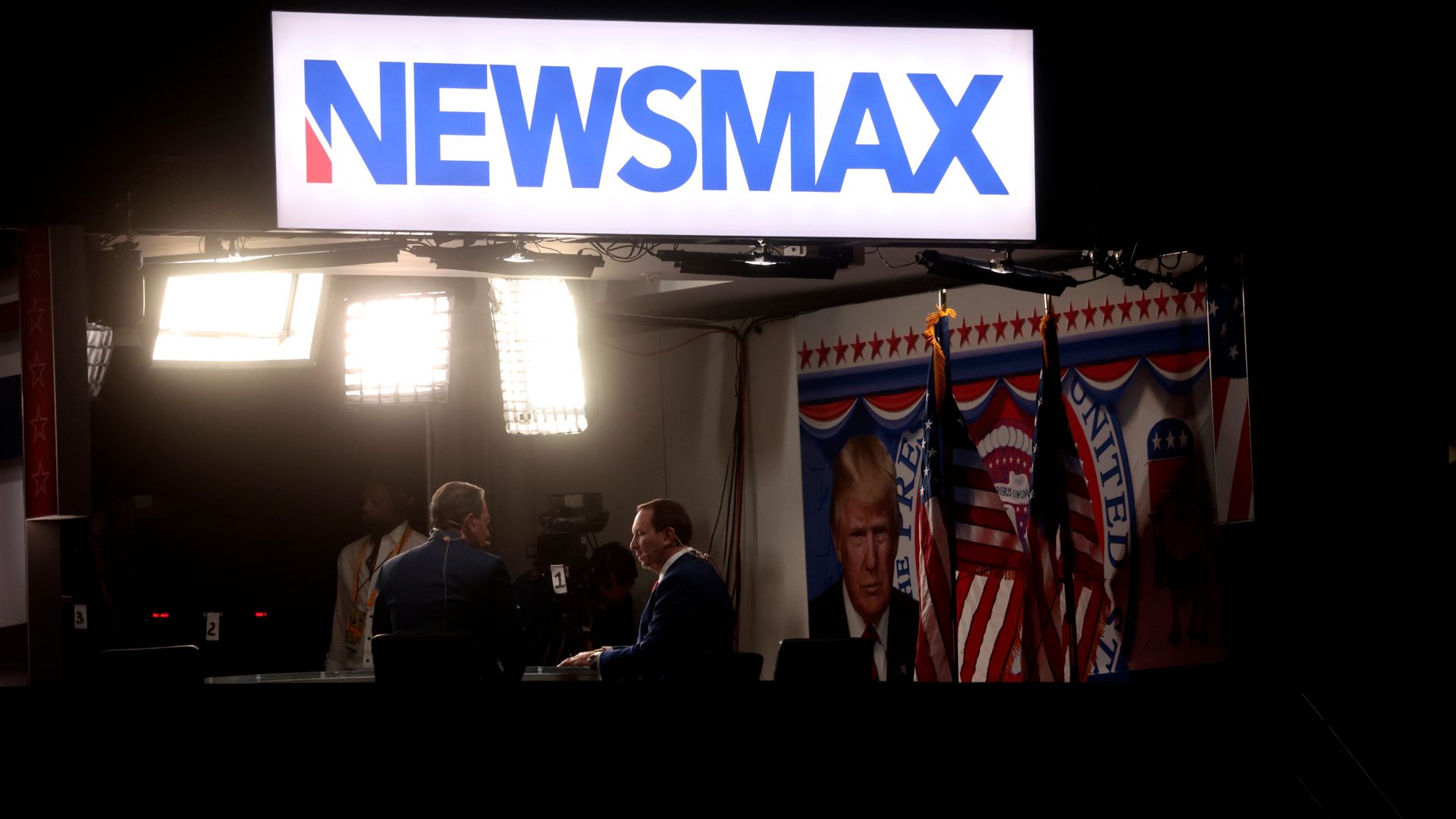 ewsmax signage during the Republican National Convention (RNC) at the Fiserv Forum in Milwaukee, Wisconsin, US, on Thursday, July 18, 2024. 