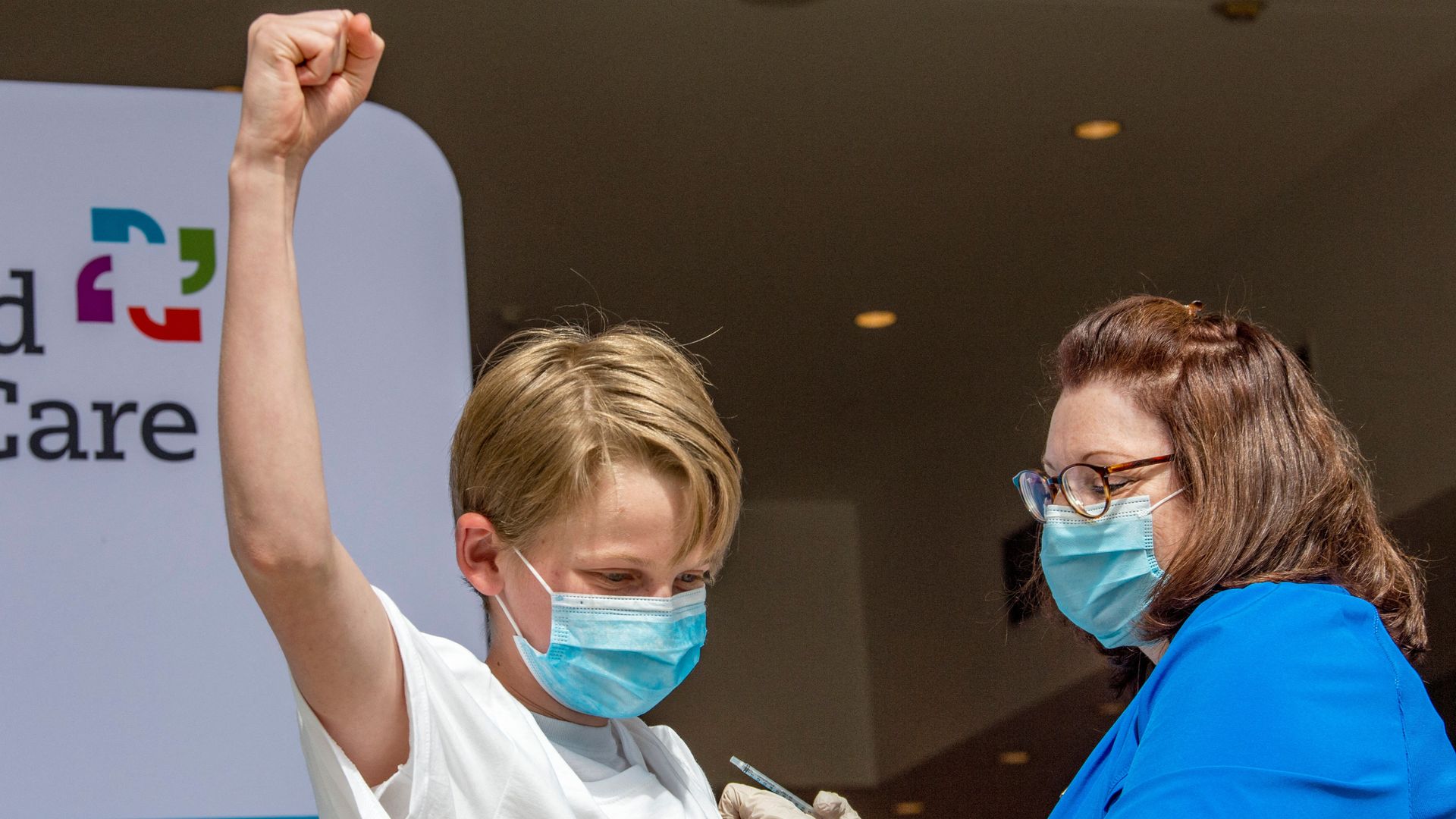 Charles Muro,age 13, celebrates being inoculated by Nurse Karen Pagliaro at Hartford Healthcares mass vaccination center at the Connecticut Convention Center in Hartford, Connecticut on May 13