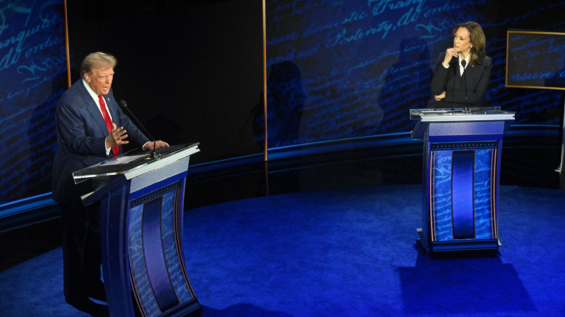 Vice President and Democratic presidential candidate Kamala Harris listens as former US President and Republican presidential candidate Donald Trump speaks during a presidential debate at the National Constitution Center in Philadelphia, Pennsylvania, on September 10, 2024.
