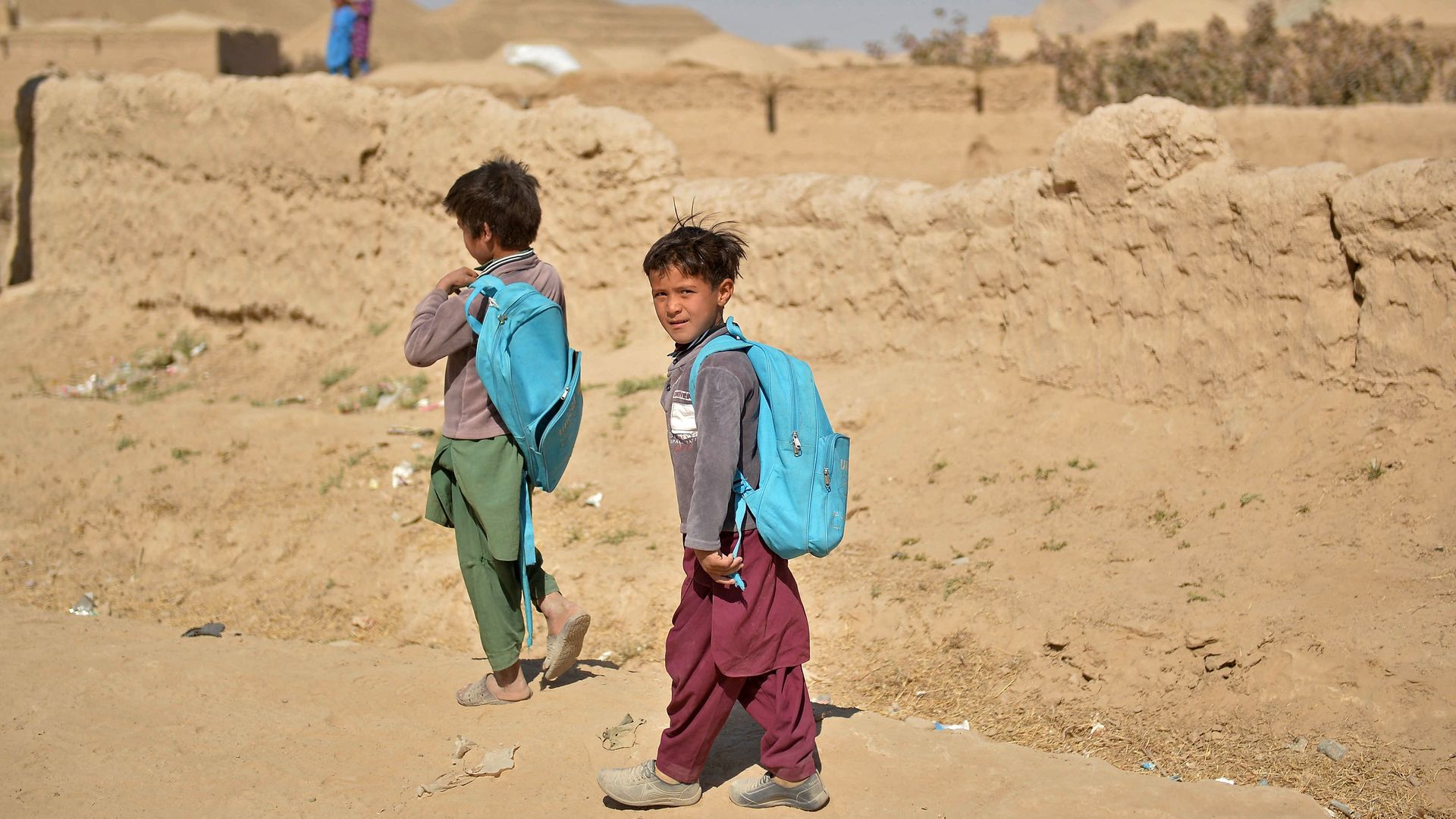 Afghan boys return to their homes after attending school 