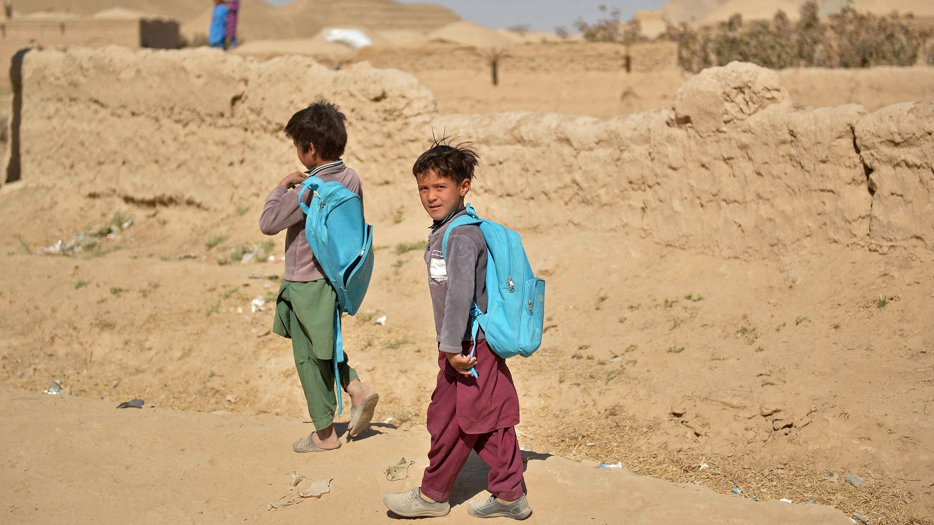 Afghan boys return to their homes after attending school