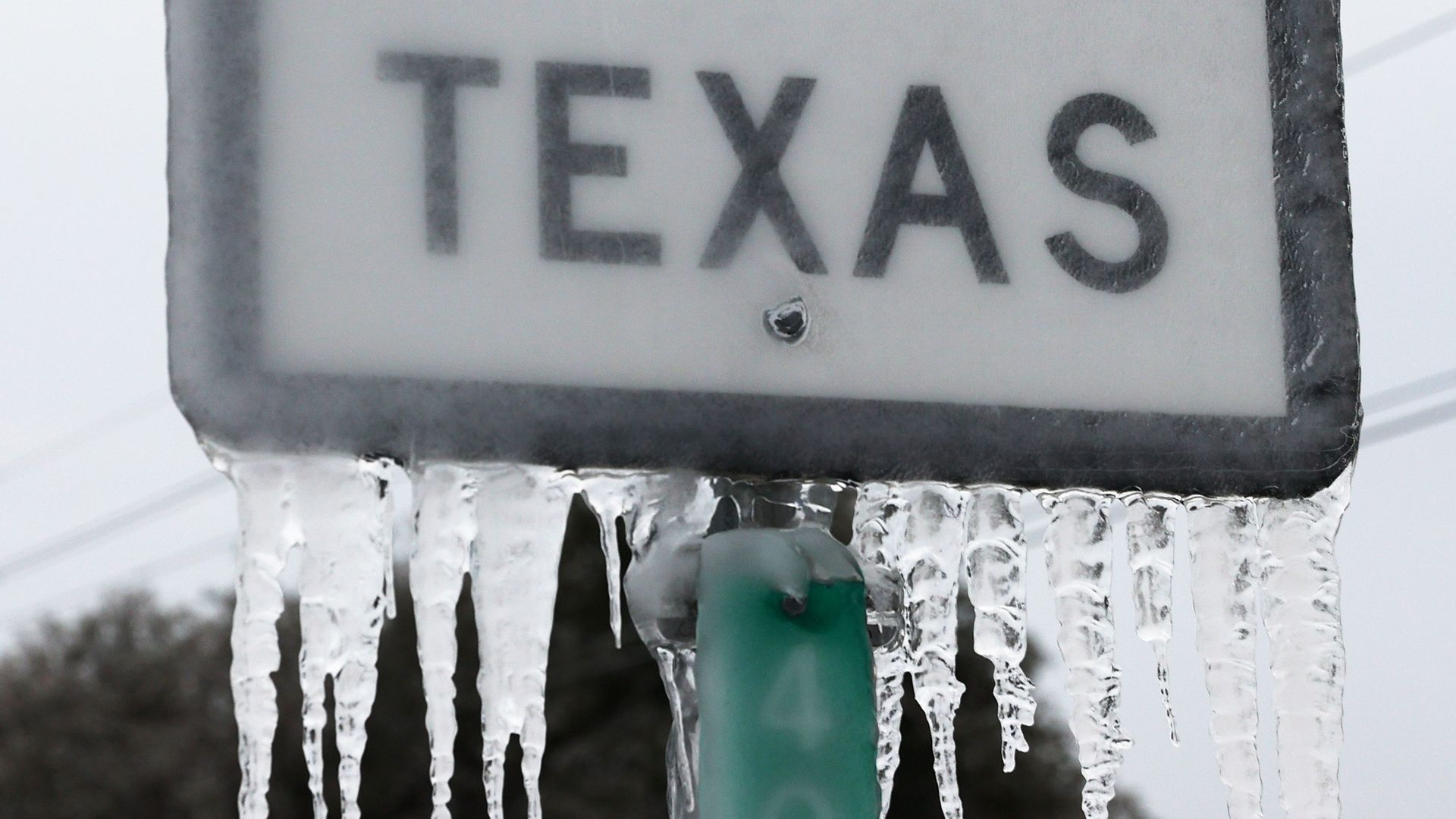 Photo of a sign that says Texas with icicles hanging on the bottom