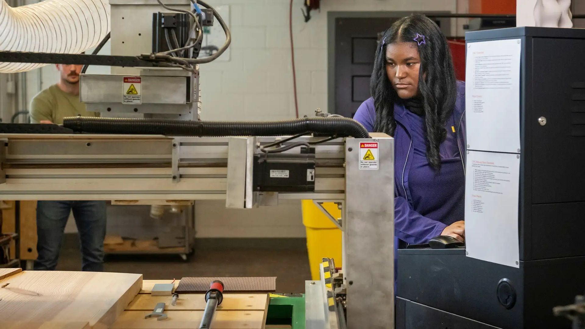 Photo shows Calcea Johnson working with machinery.