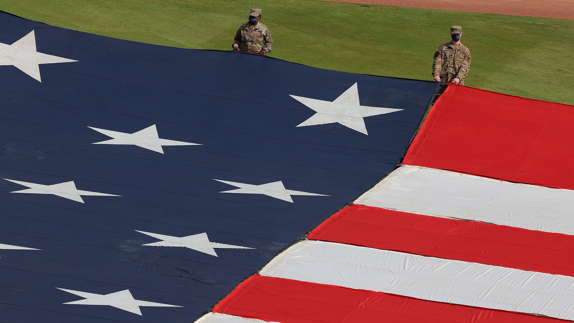 - MAY 31: Members of the military hold a large American flag in the outfield during pregame ceremoni