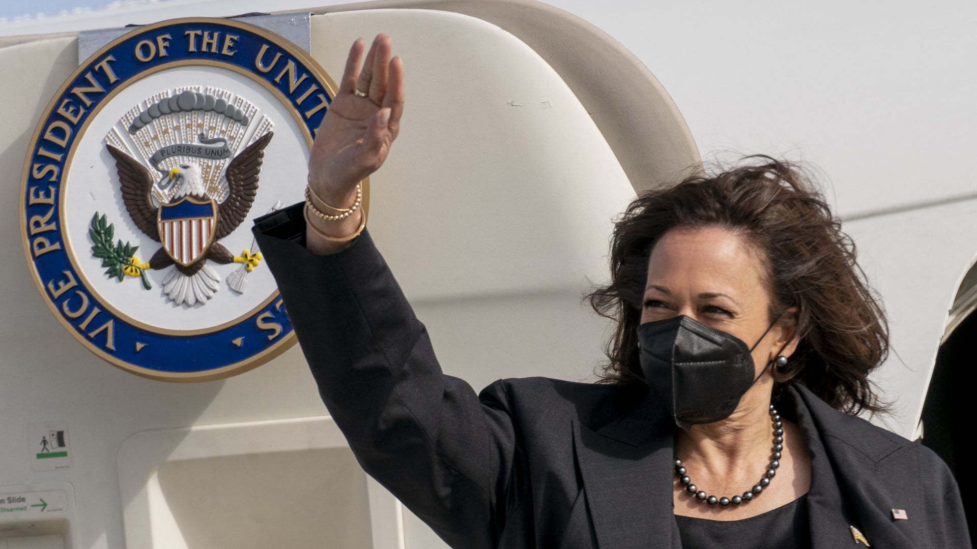 US Vice President Kamala Harris waves as she boards her airplane to Washington after attending the Munich Security Conference.