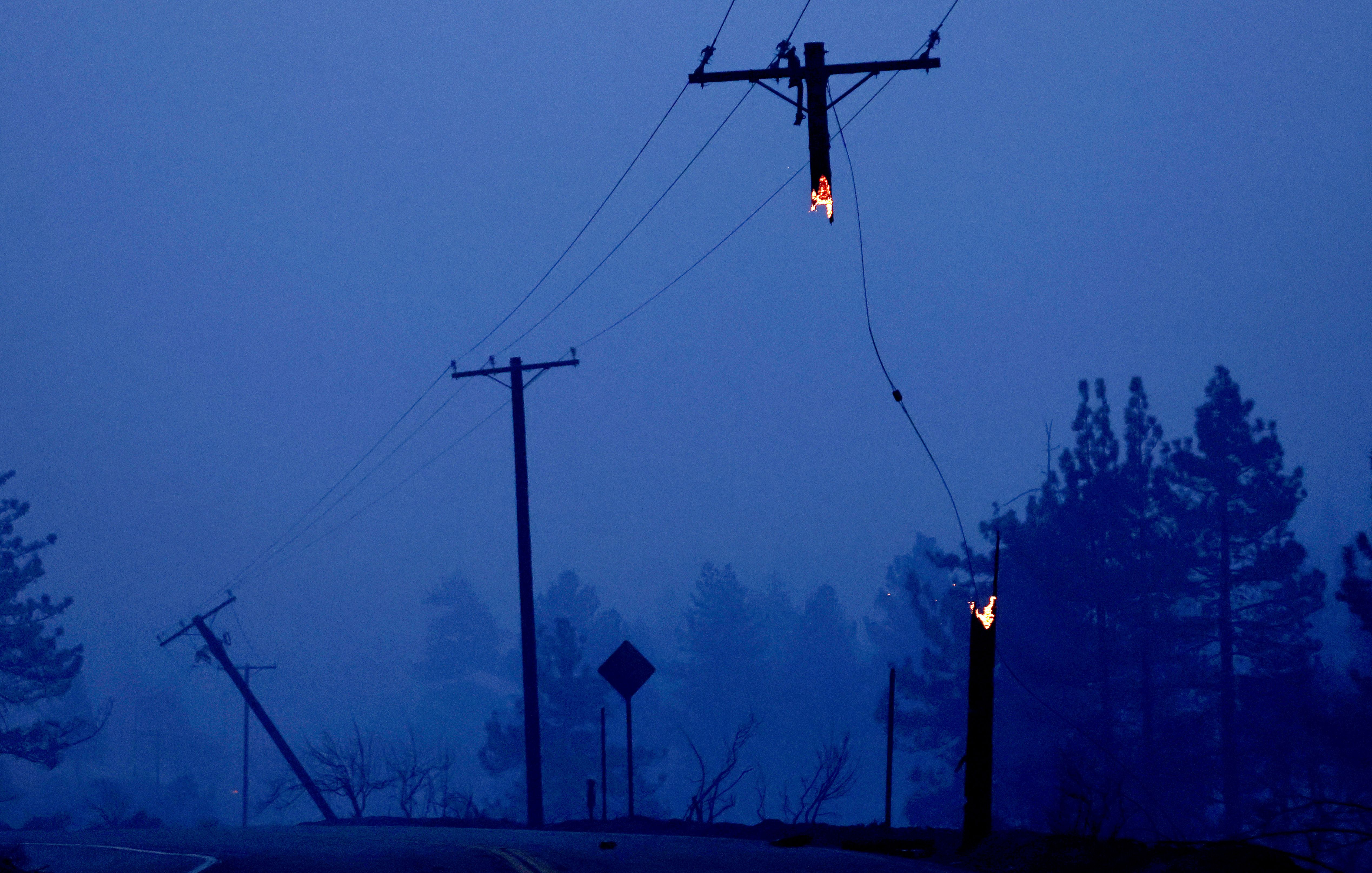 Fire damaged power lines are viewed at dawn during the Bridge Fire which has now burned more than 47,000 acres in Angeles National Forest on September 11, 2024 in Wrightwood, California. 