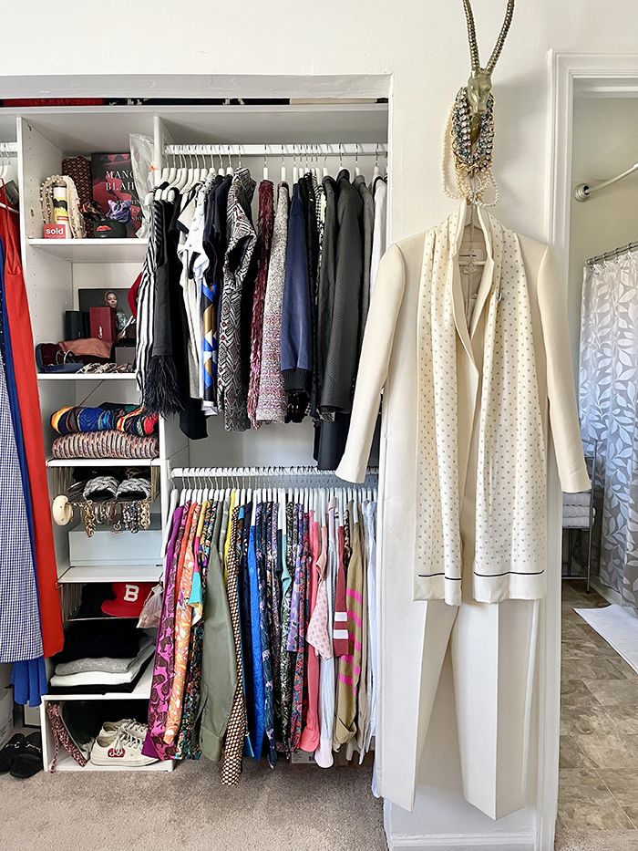 Eboney Foster plaza midwood apartment home tour closet with outfit displayed