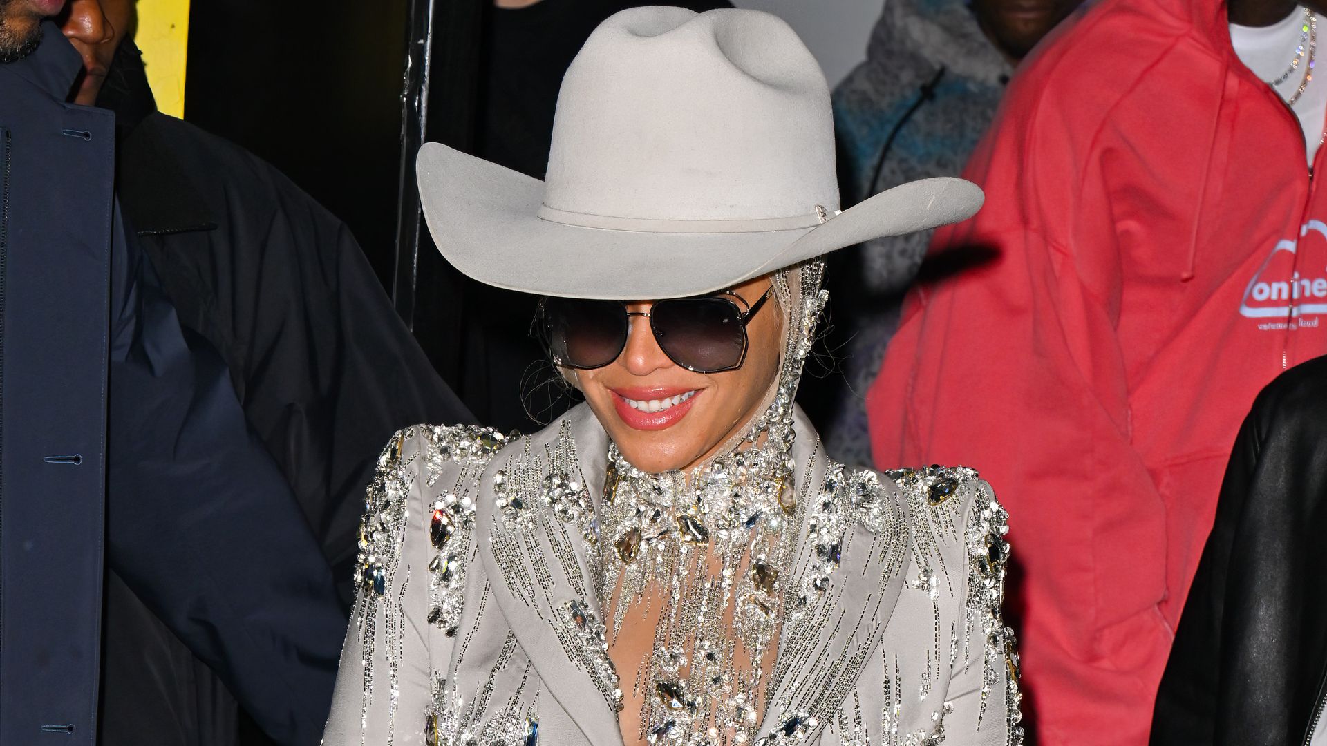 Beyonce smiling in a cowboy hat.