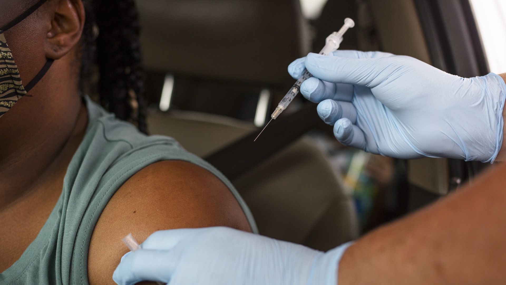 A photo of a person waiting to receive the COVID vaccine