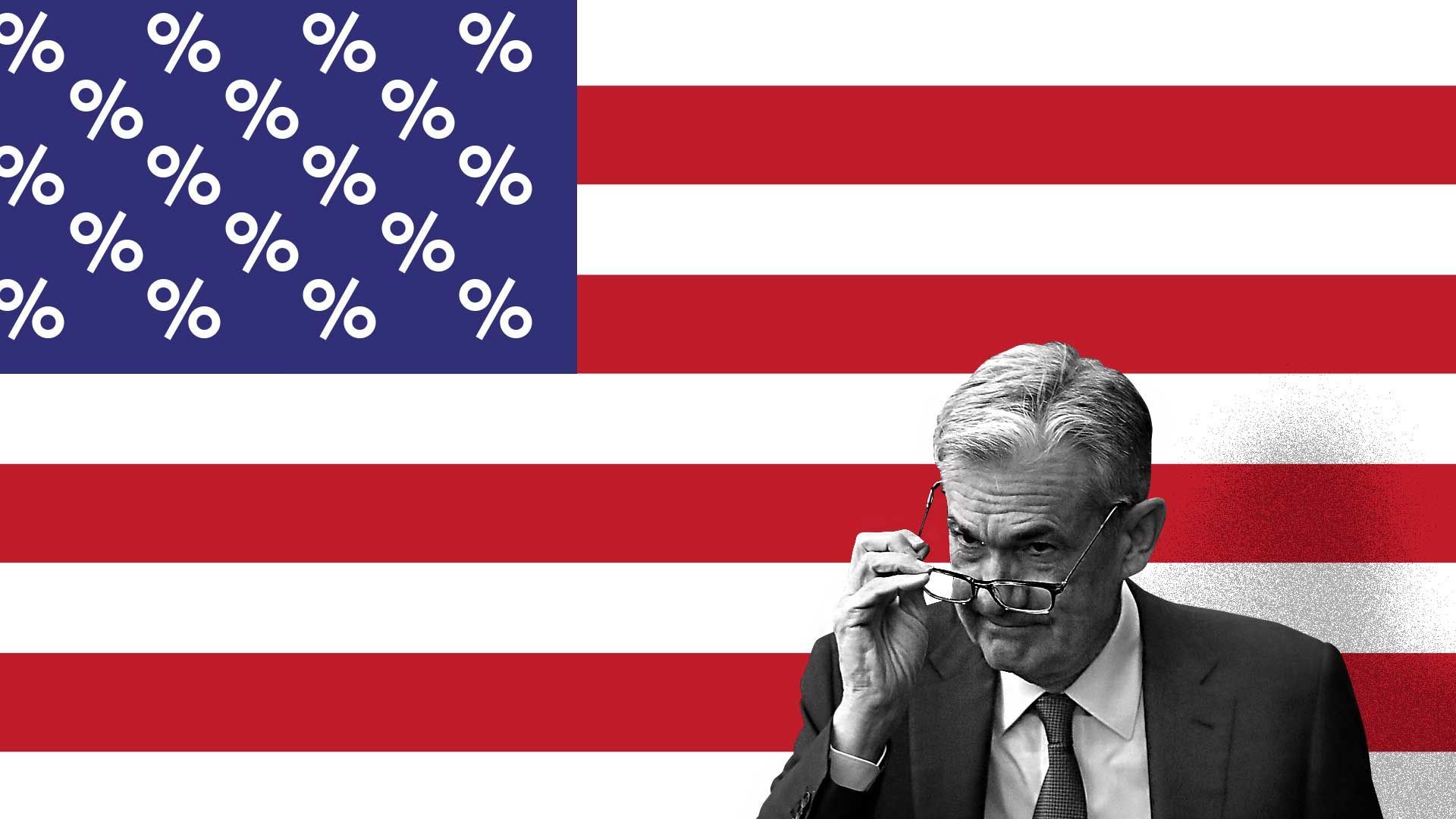 Jay Powell standing in front of a U.S. flag with the stars replaced by percent signs