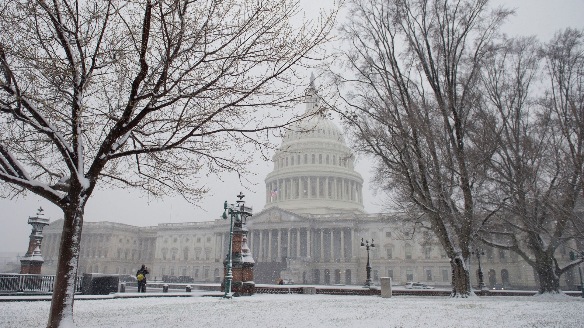 Snow falls on Capitol Hill.