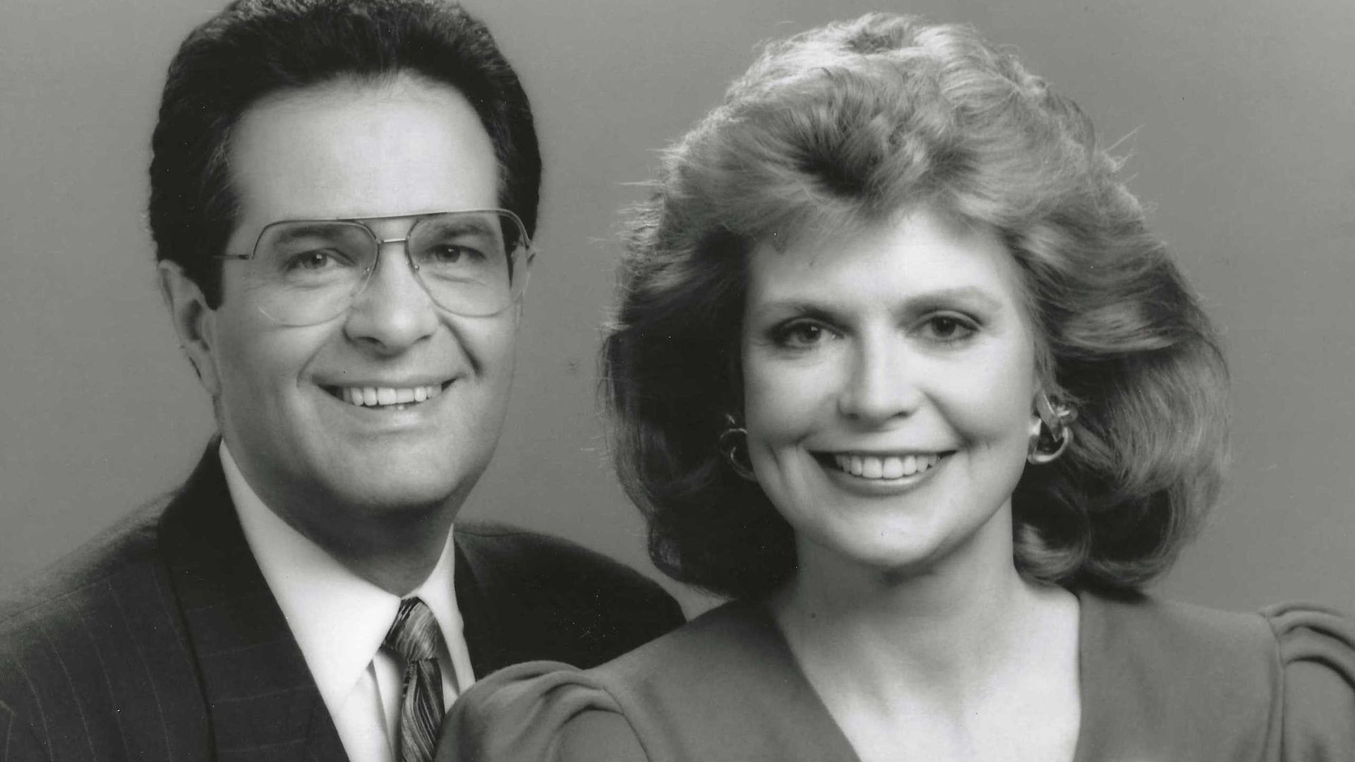 Photo of two dressed up people in a headshot 