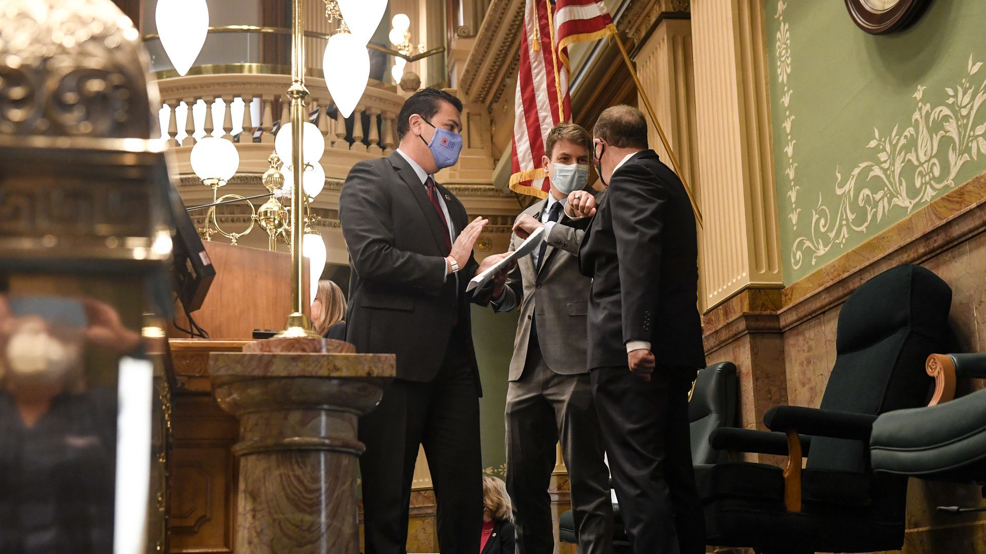 Colorado Gov. Jared Polis elbow bumps State House Speaker Alec Garnett ahead of a joint address.