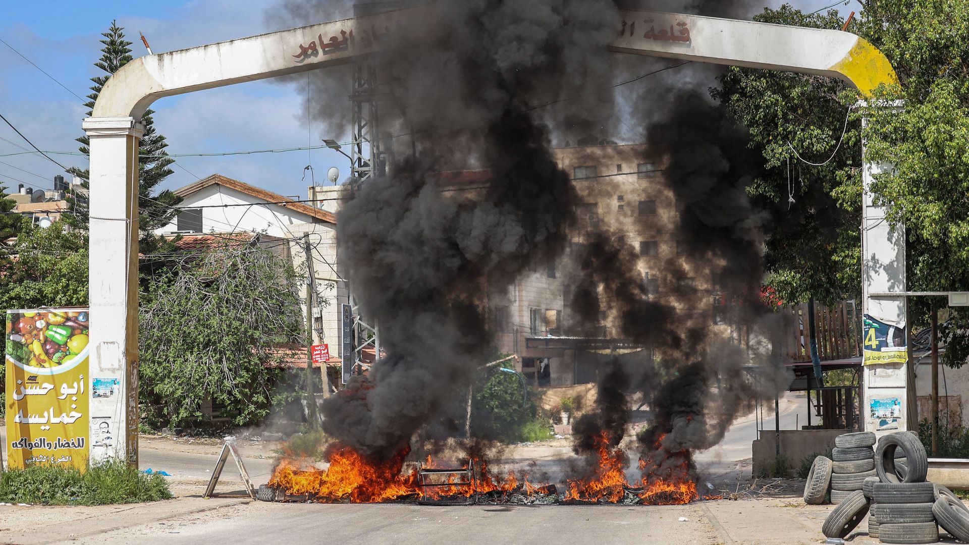 Tires are set aflame at an entrance to the Palestinian refugee camp of Jenin in the occupied West Bank on April 9. Photo: Jaafar Ashtiyeh/AFP via Getty Images