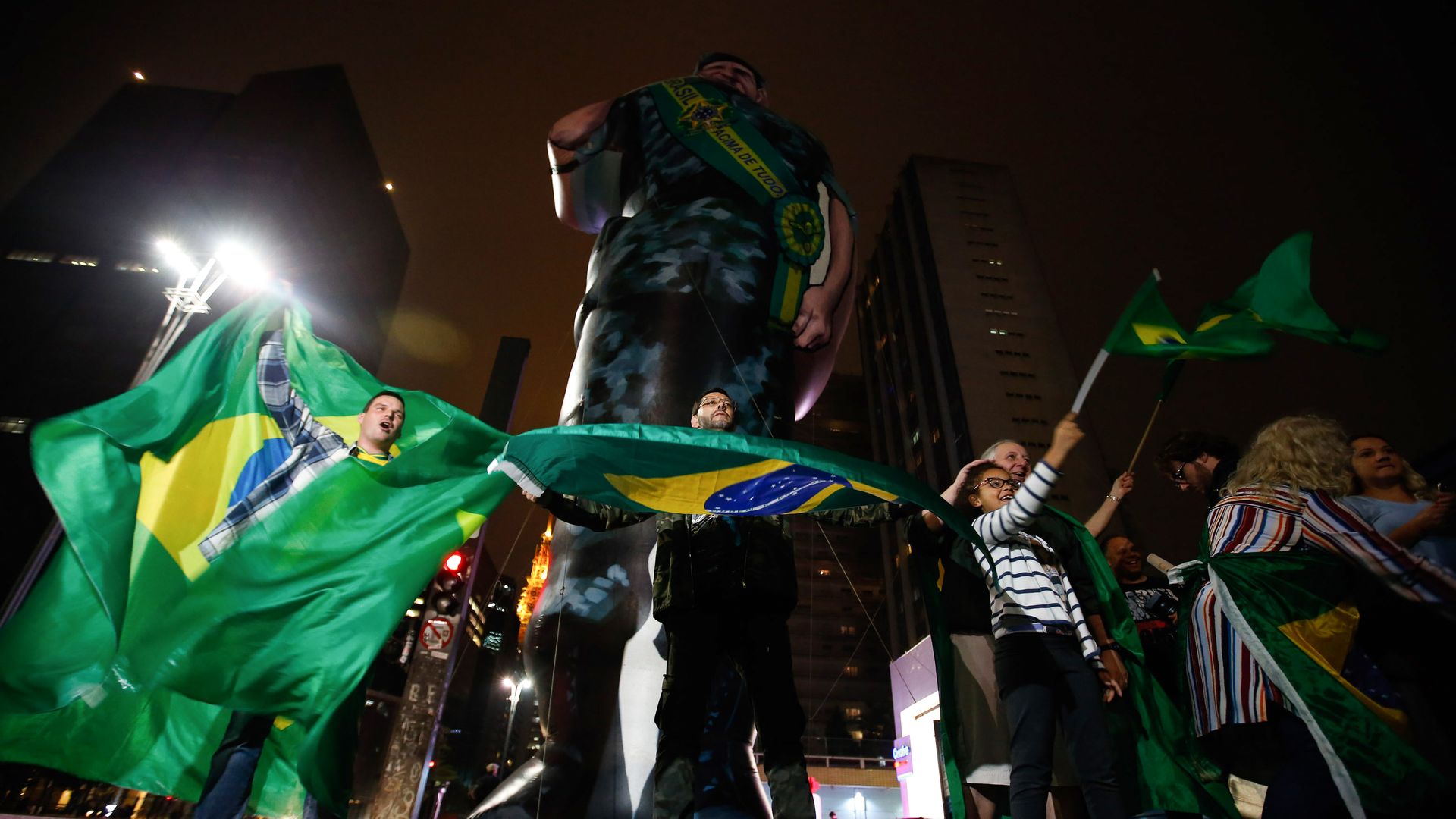 Supporters of Jair Bolsonaro wave Brazilian flags
