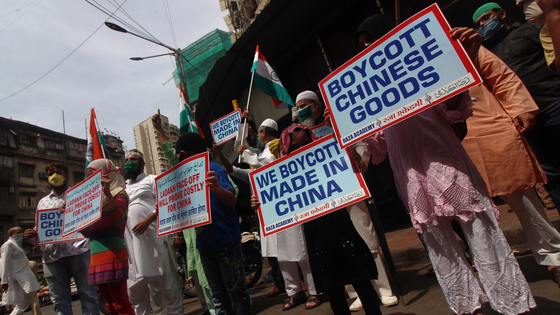 Muslim activists hold placards and shout slogans against China during a protest in Mumbai