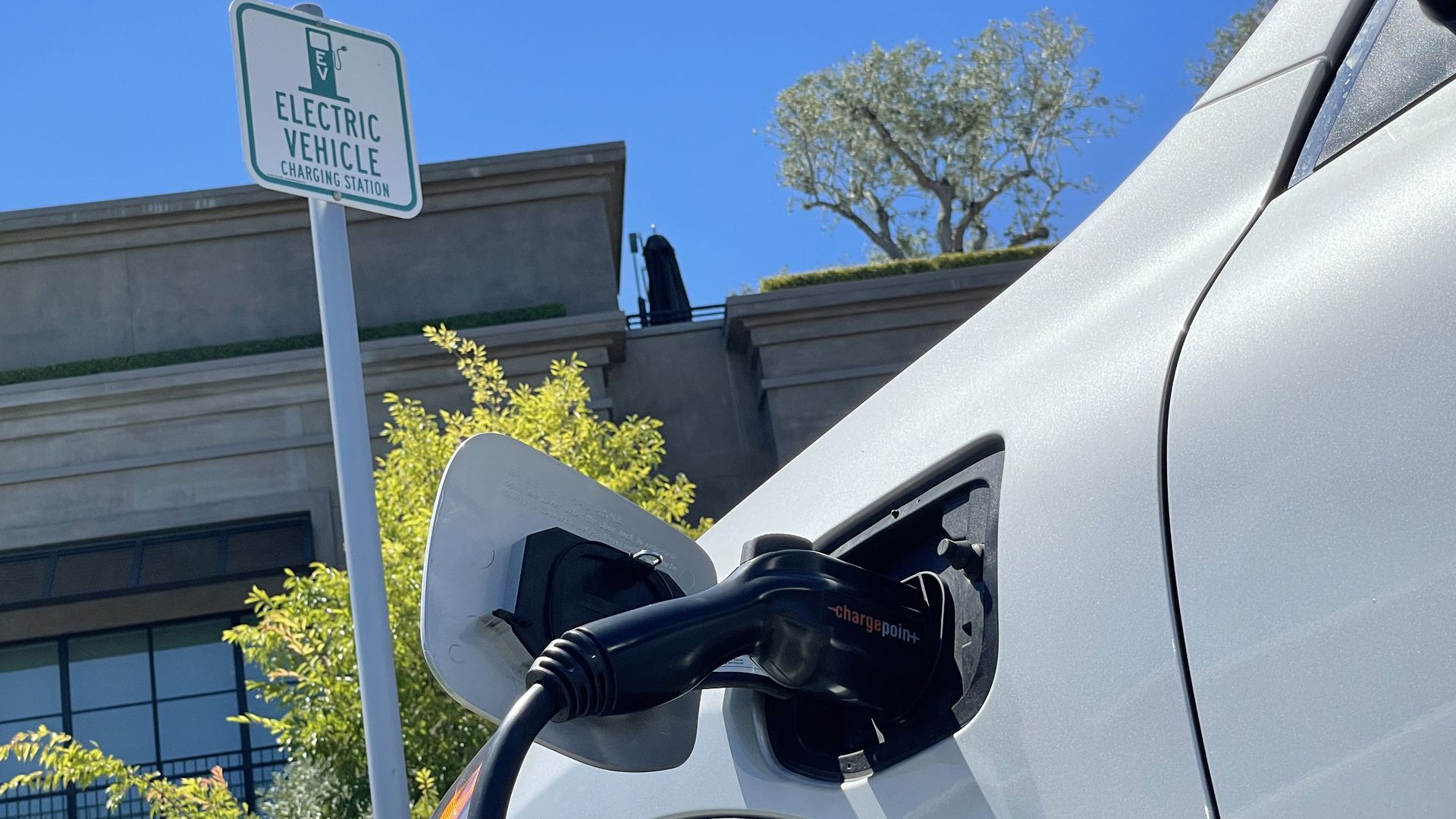 An electric car charges at a mall parking lot on June 27, 2022 in Corte Madera, California.