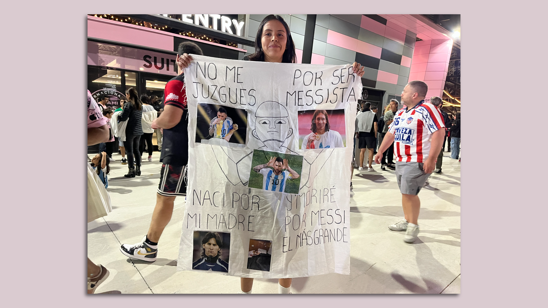 An Inter Miami fan holds up a sign praising Lionel Messi.