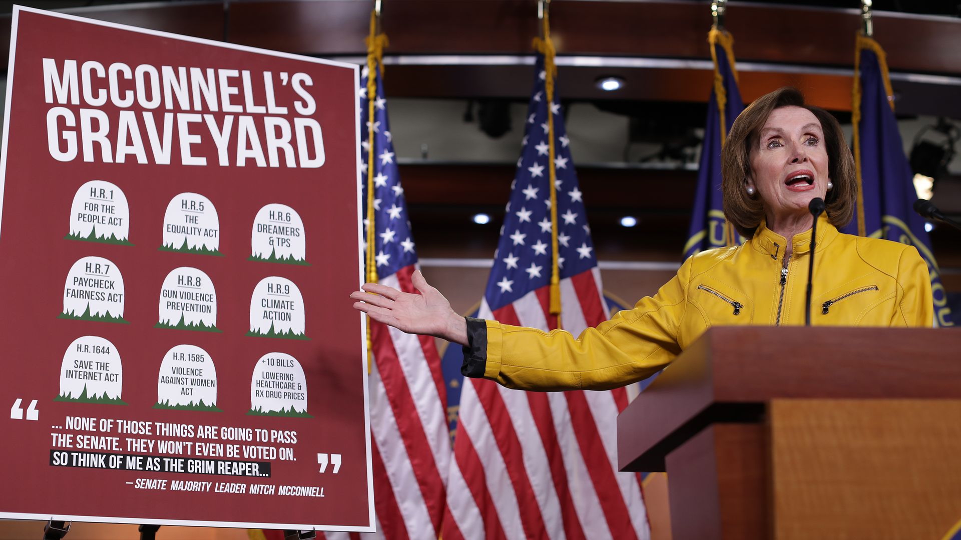 House Speaker Nancy Pelosi with a sign about "McConnell's Graveyard"