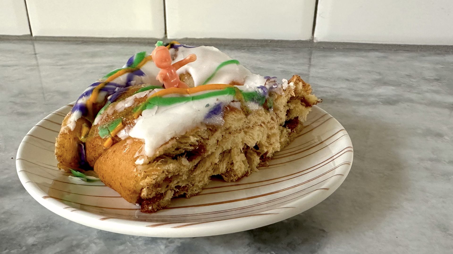 Photo shows a slice of king cake