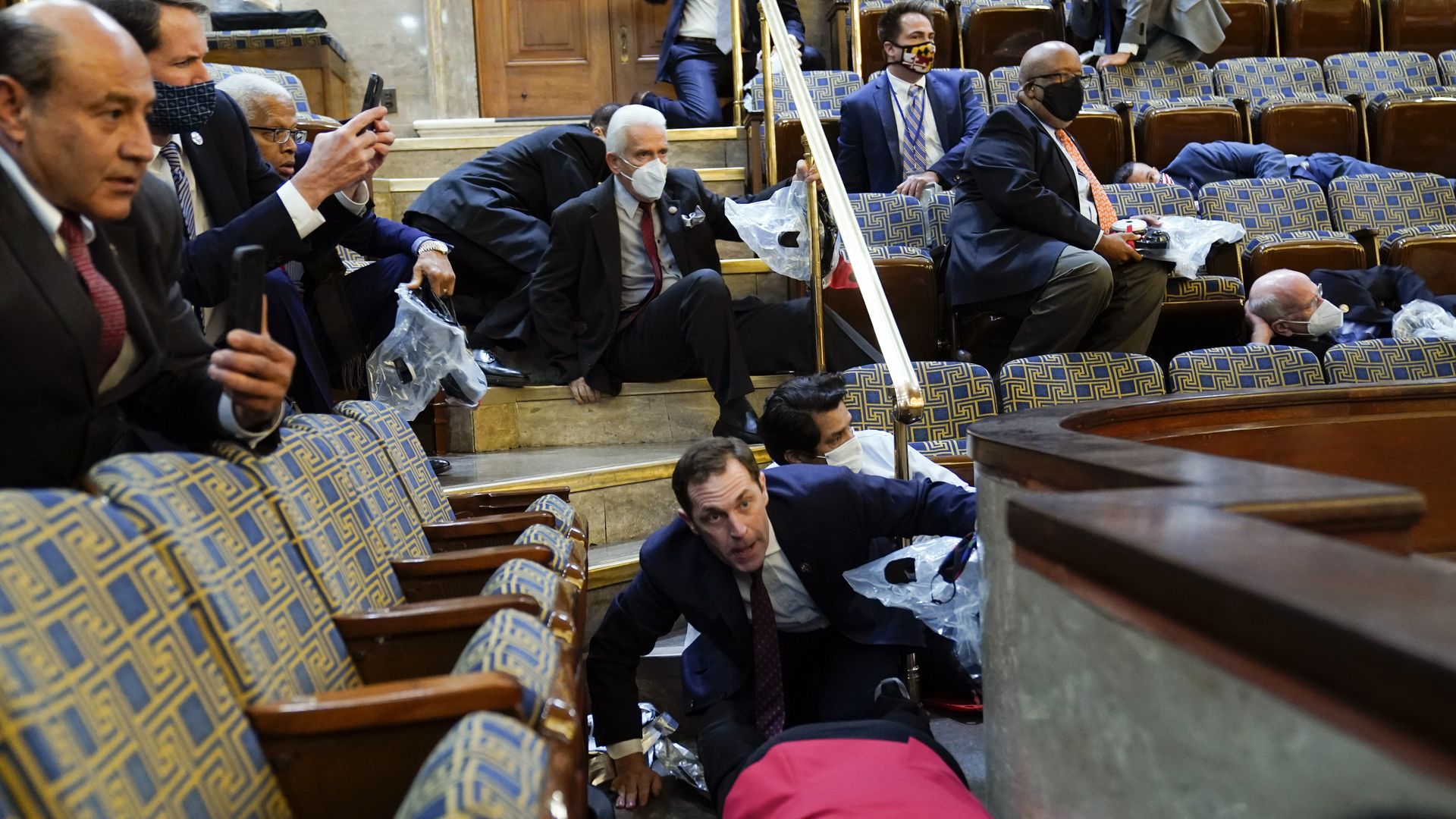 Members of the House seek cover as pro-Trump forces seize control of the Capitol.