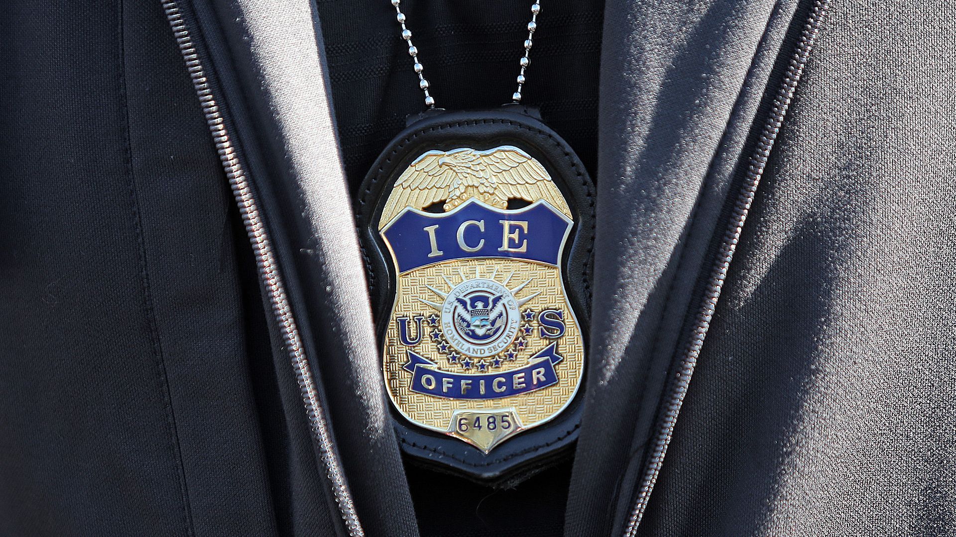 A close up of an ICE Officer badge