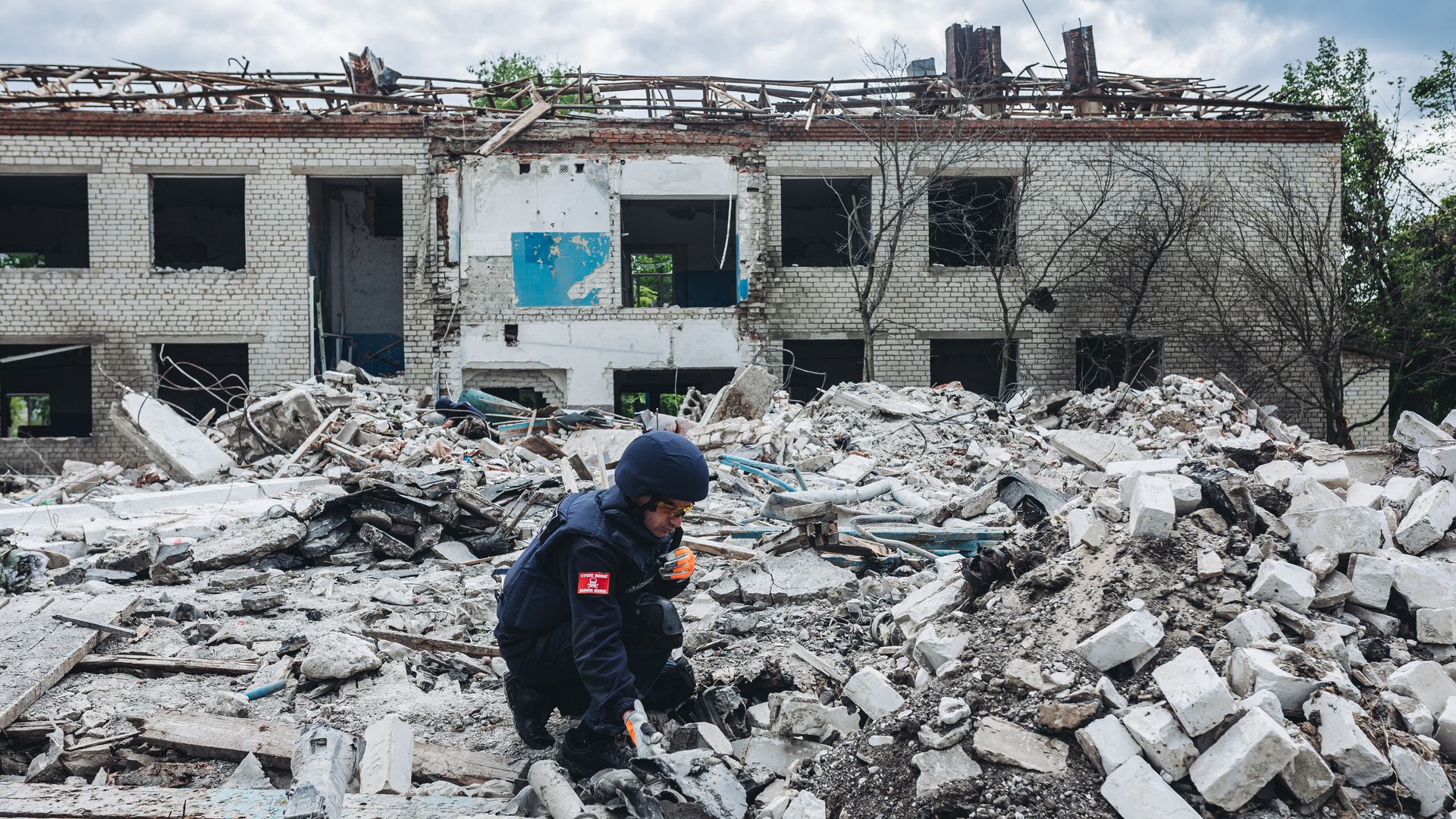 Man digs through rubble in Ukraine