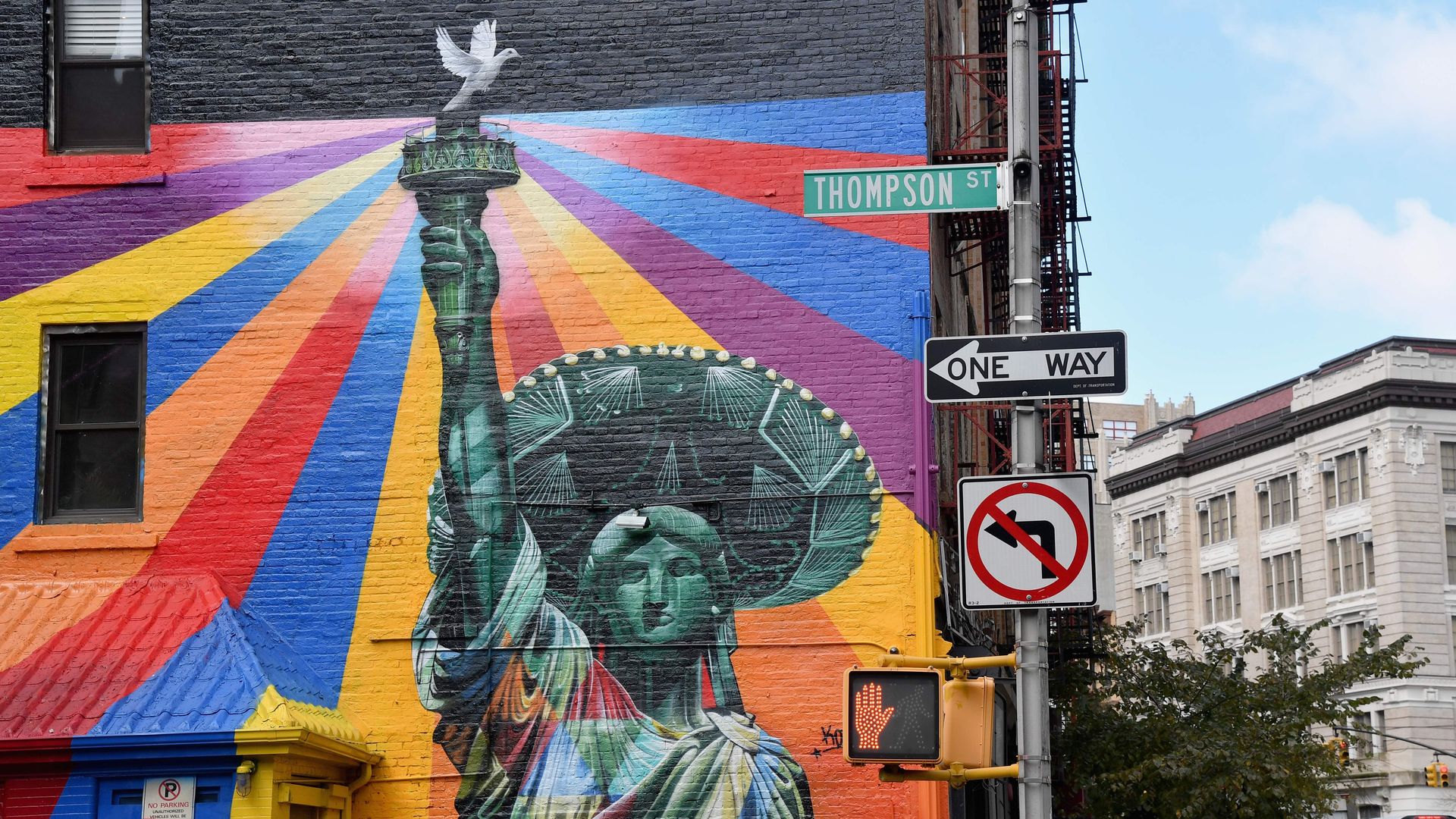 A colorful mural painted on a wall in New York City of the Statue of Liberty