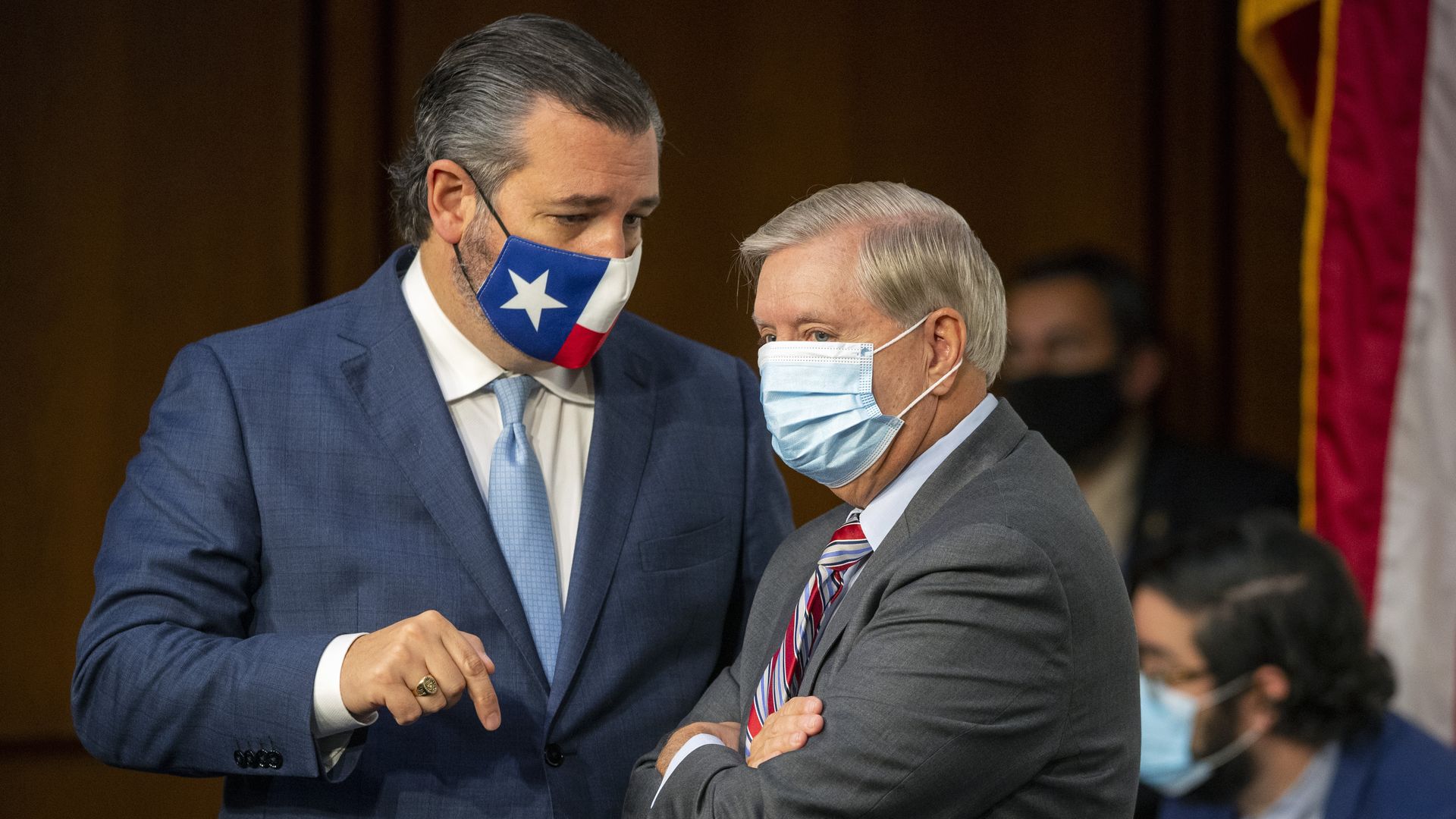 Cruz and Graham stand while wearing face masks