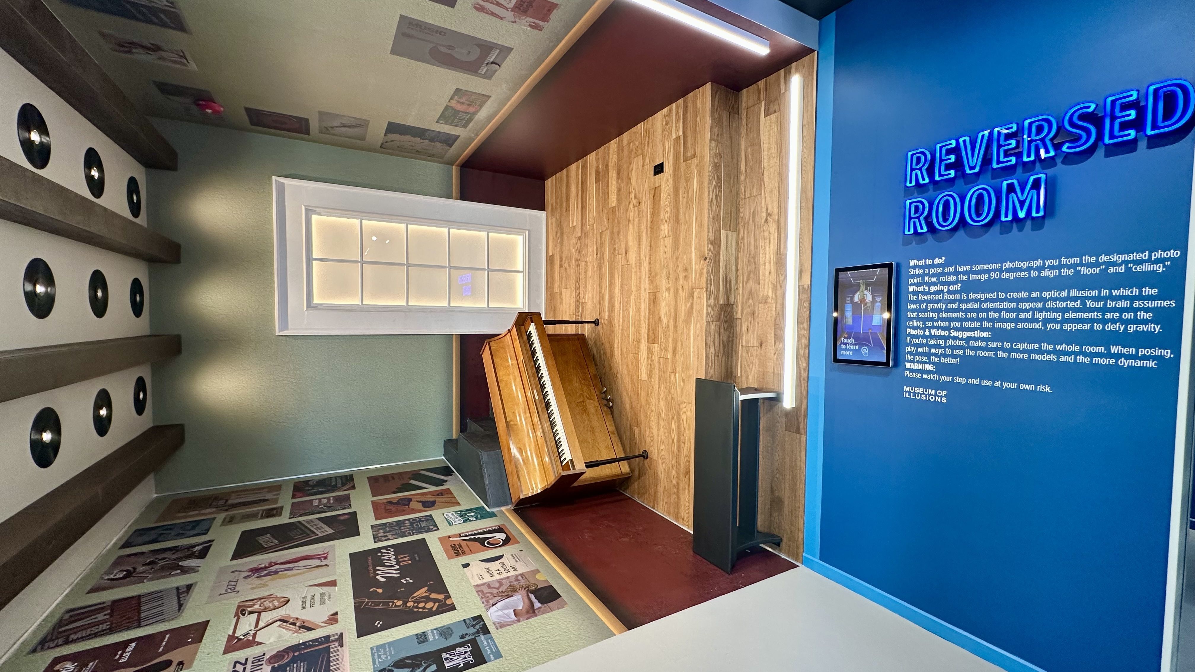 Photo shows a jazz room with a piano mounted on the wall.