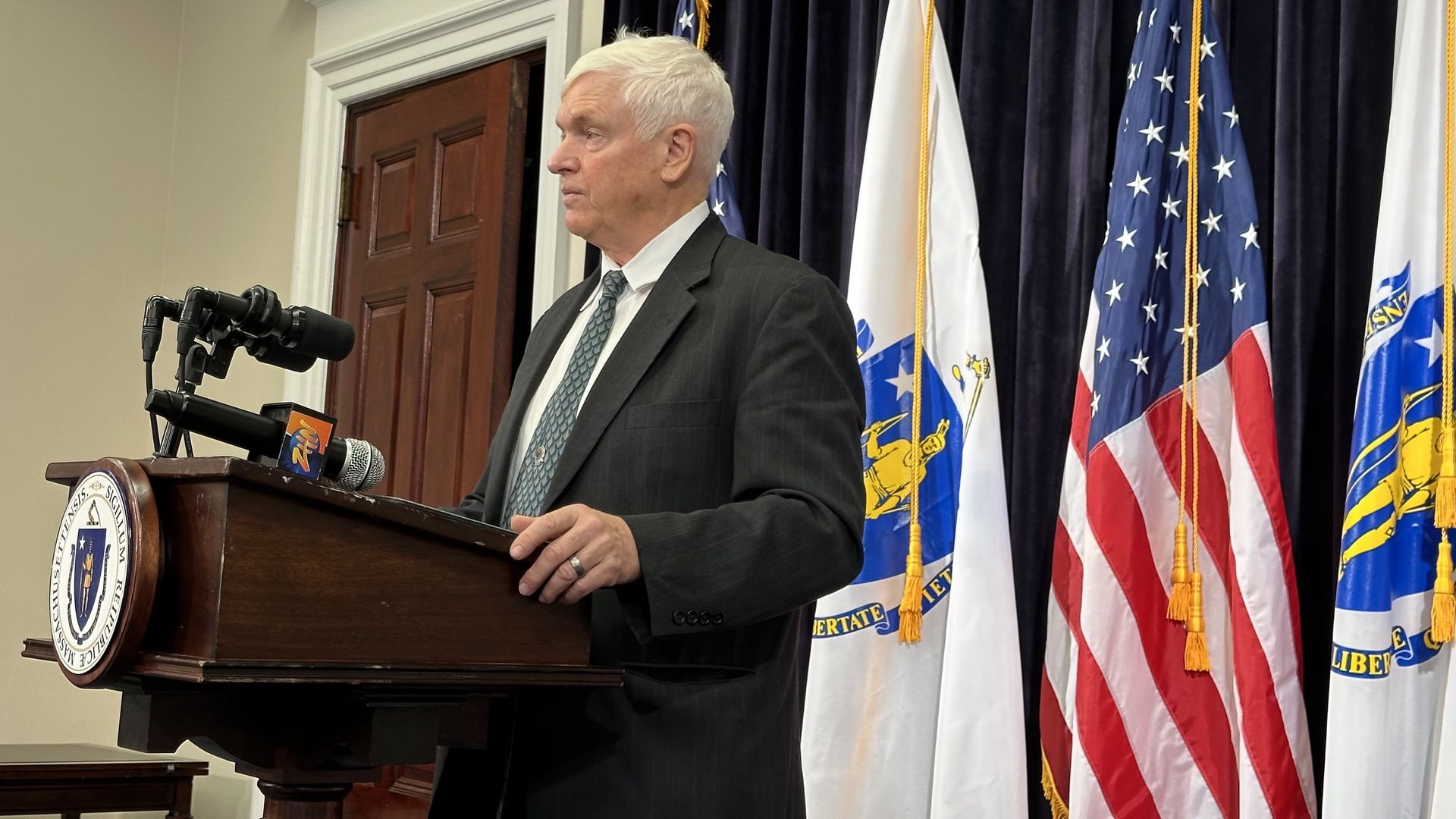 Gen. L. Scott Rice, the state's emergency assistance director, speaks from a podium in the State House.