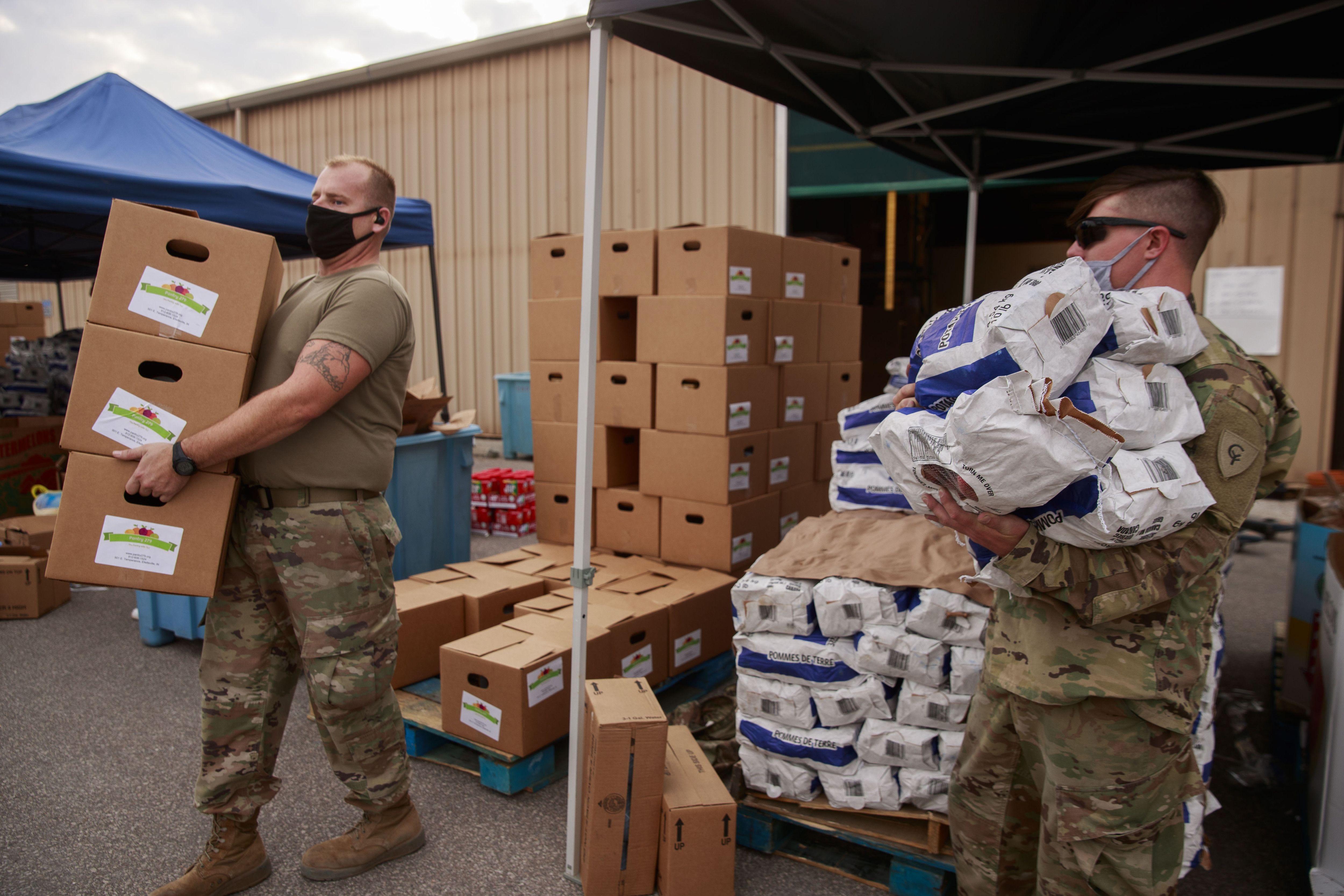 National Guard carries bags of flours