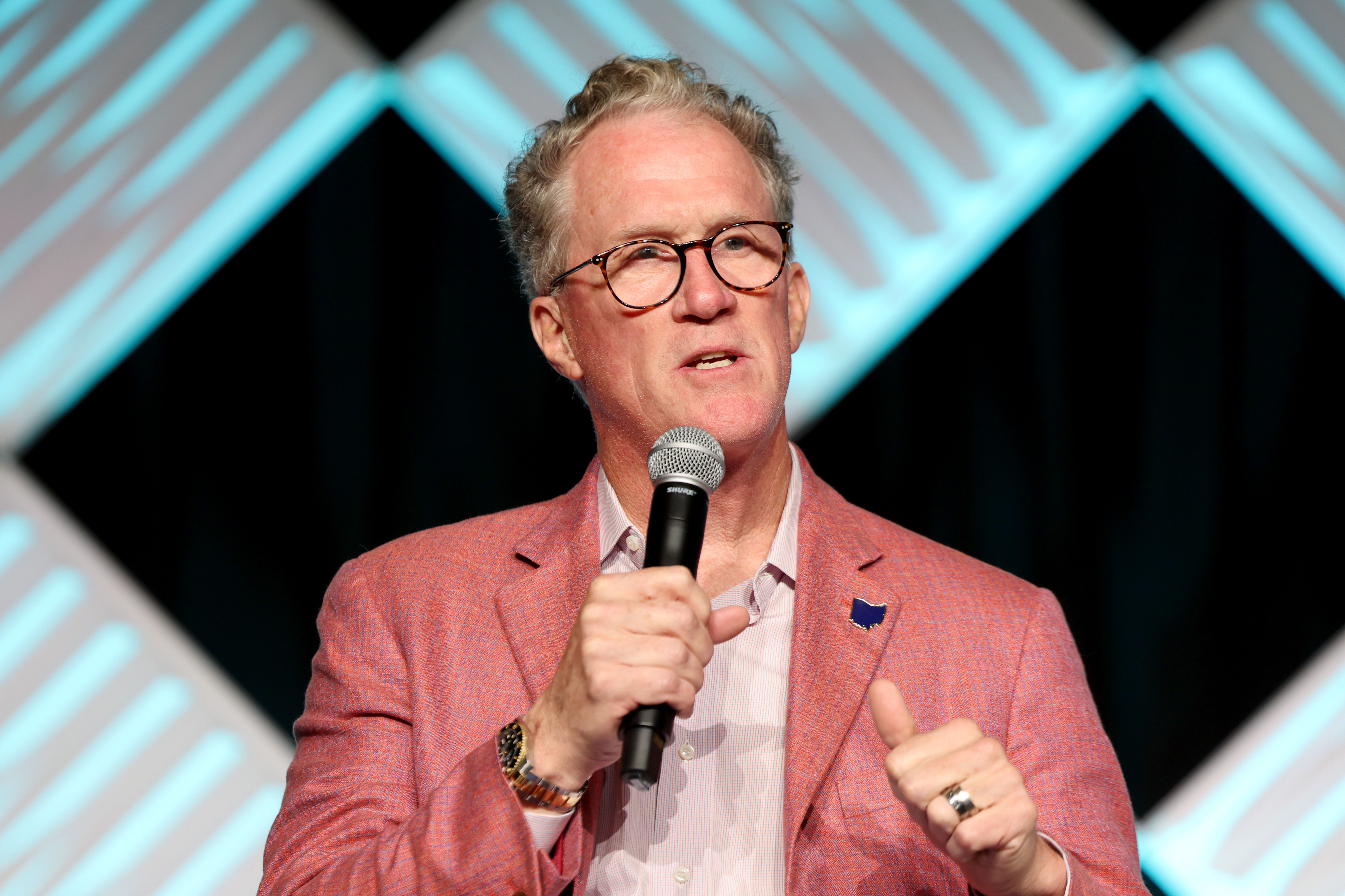 Mark Kvamme holds a microphone on stage