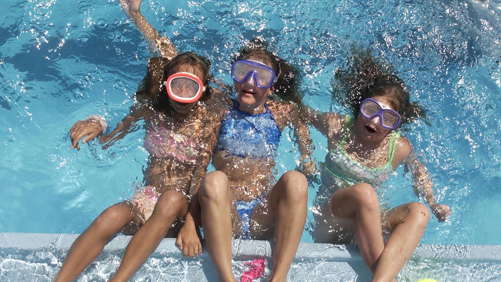 A photo of young girls in a pool