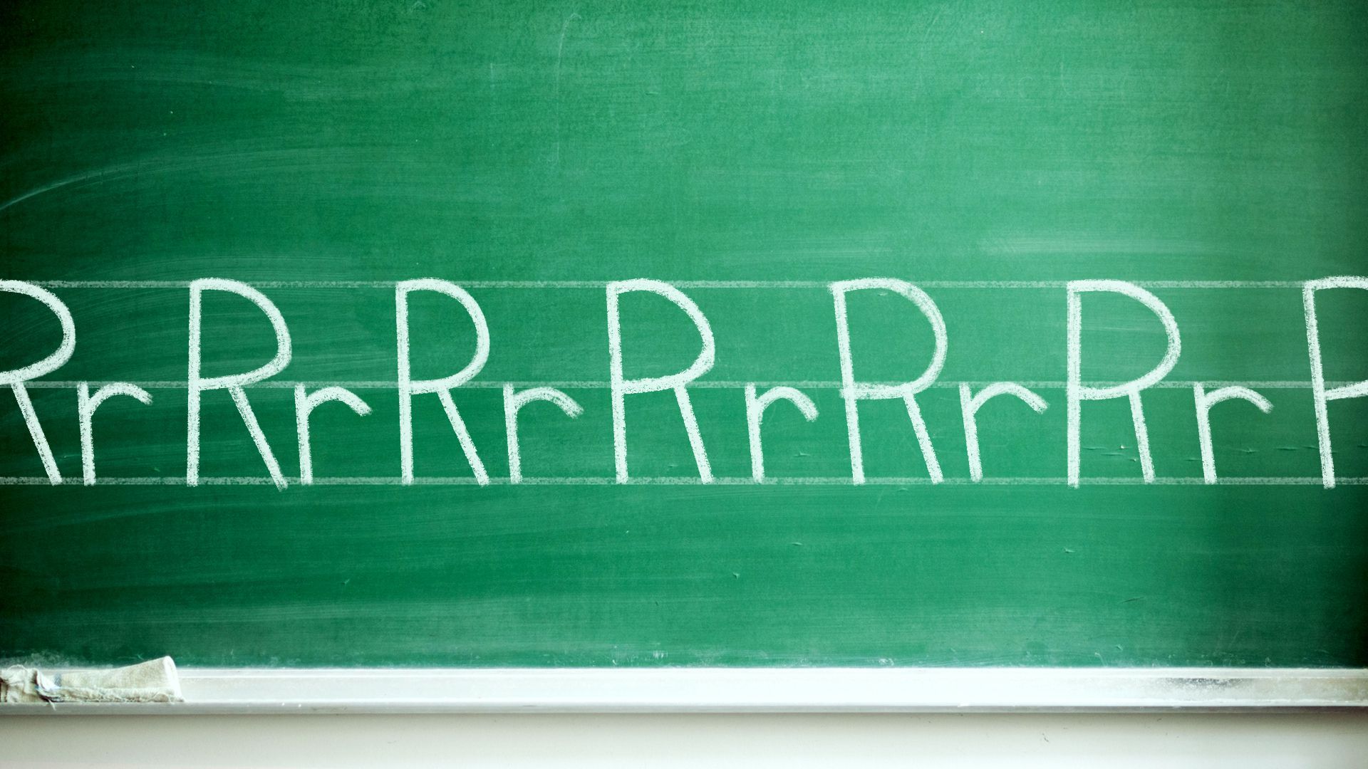 Illustration of a chalkboard with the alphabet written on it, but every letter is "R."