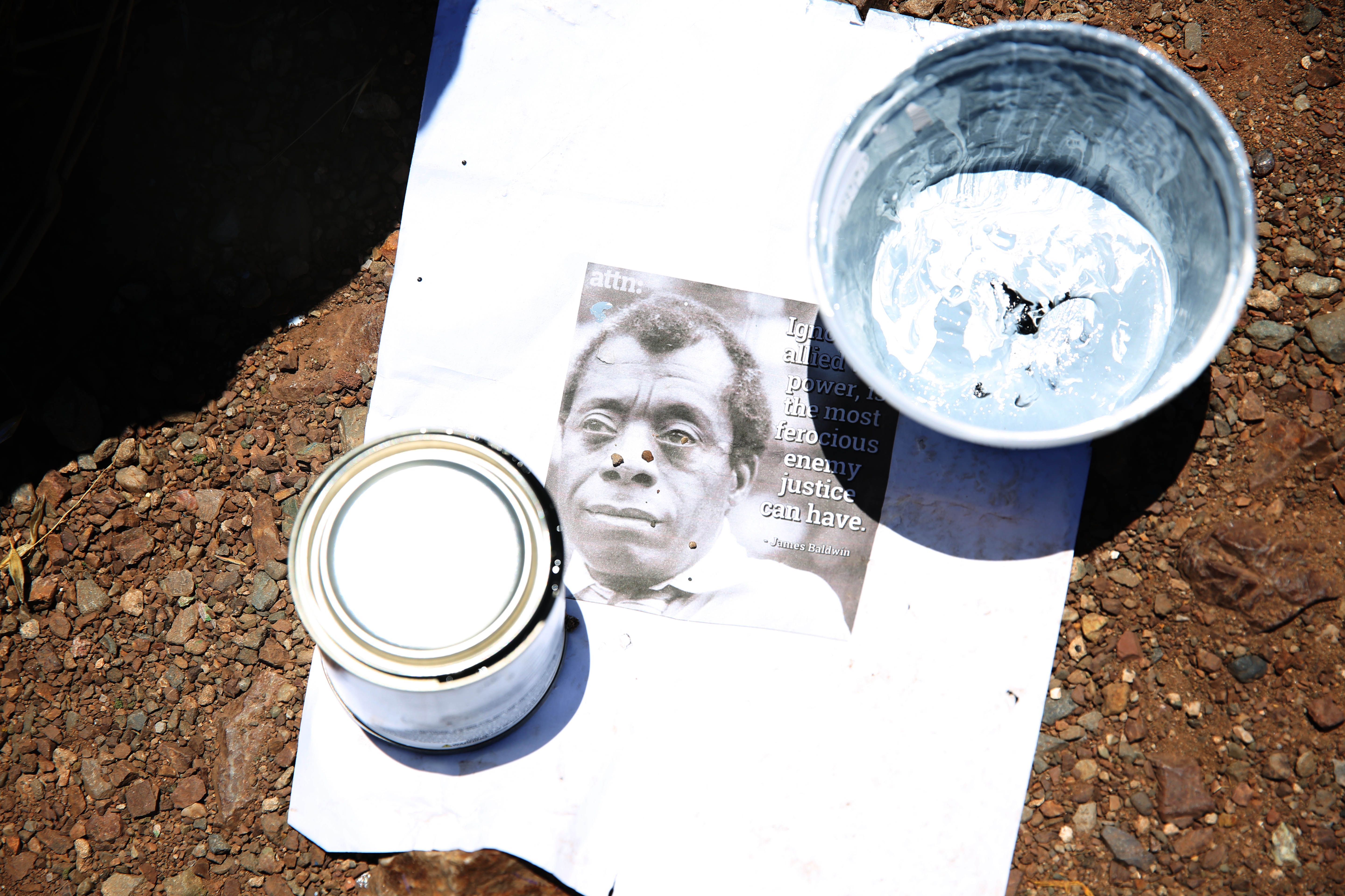 A photo and quote of James Baldwin is seen on a piece of paper after it was painted onto a boulder alongside Folsom Street on Monday, June 8, 2020 in San Francisco, Calif. Kseniya Makarova painted the rock for Black Lives Matter.
