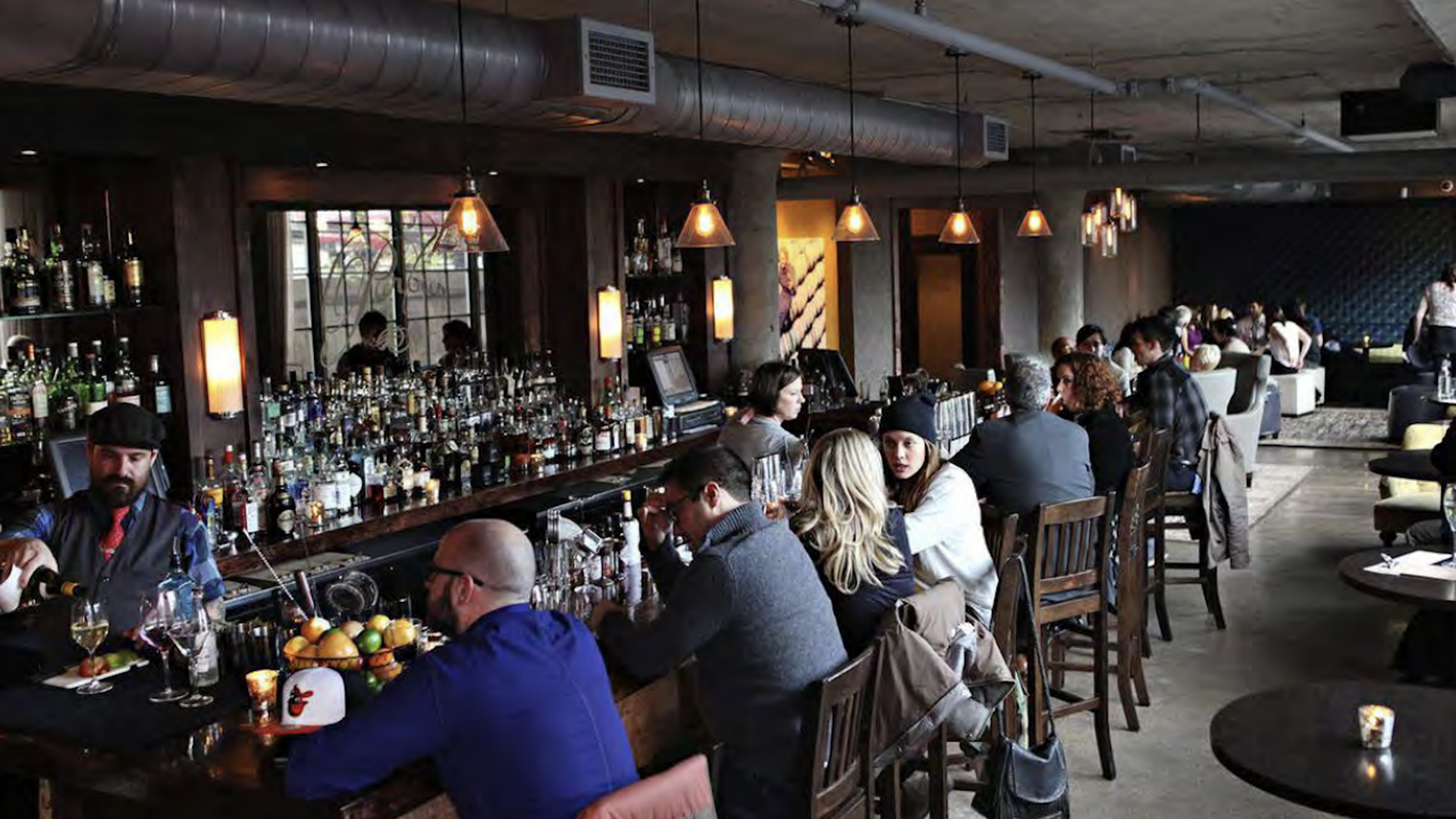 Patrons sit at the bar inside Parlour in Minneapolis.