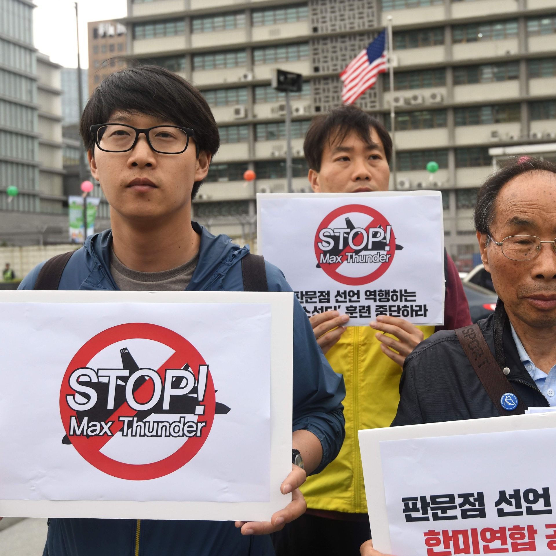 South Korean peace activists hold placards reading 'Stop! Max Thunder,' during a rally denouncing South Korea-US joint military drills, in front of the US embassy in Seoul on May 16, 2018.
