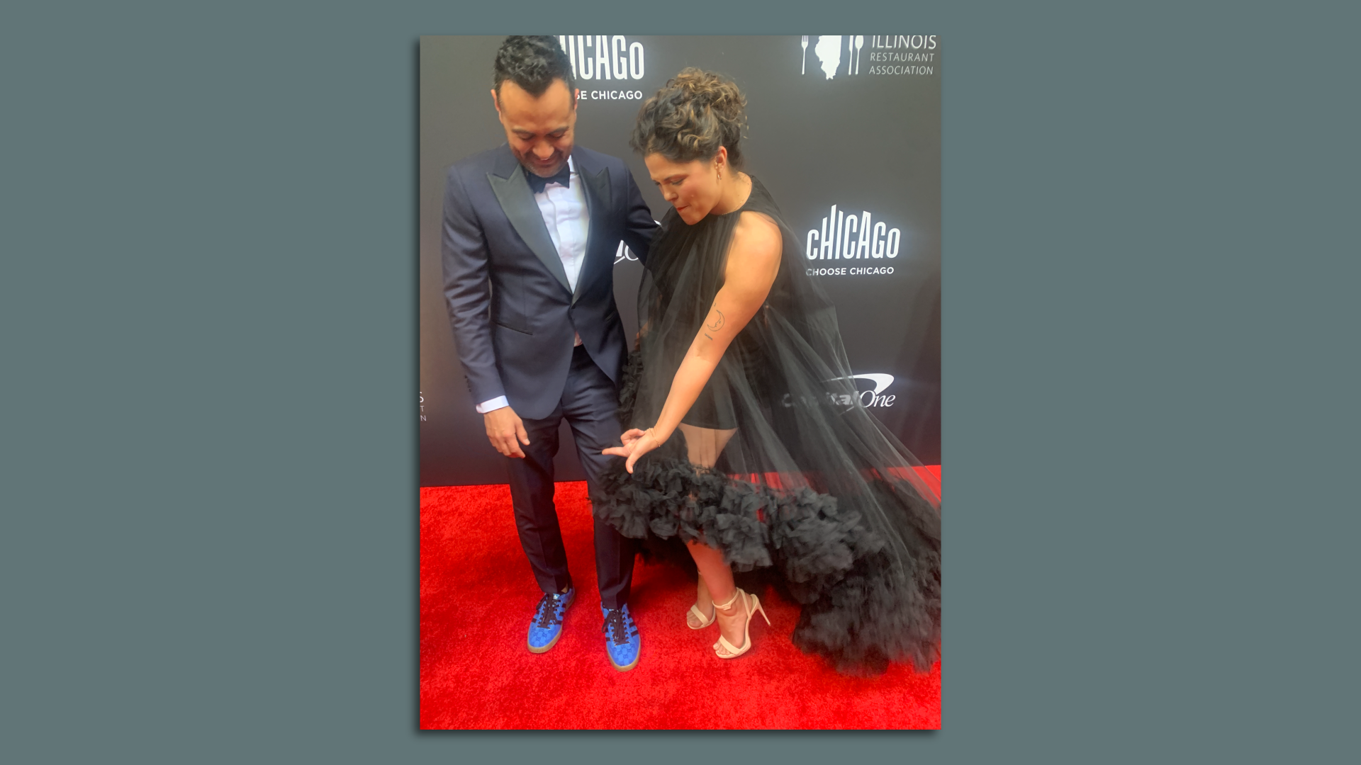 Michael Diaz De Leon from Denver and his date show off their shoes on the red carpet.