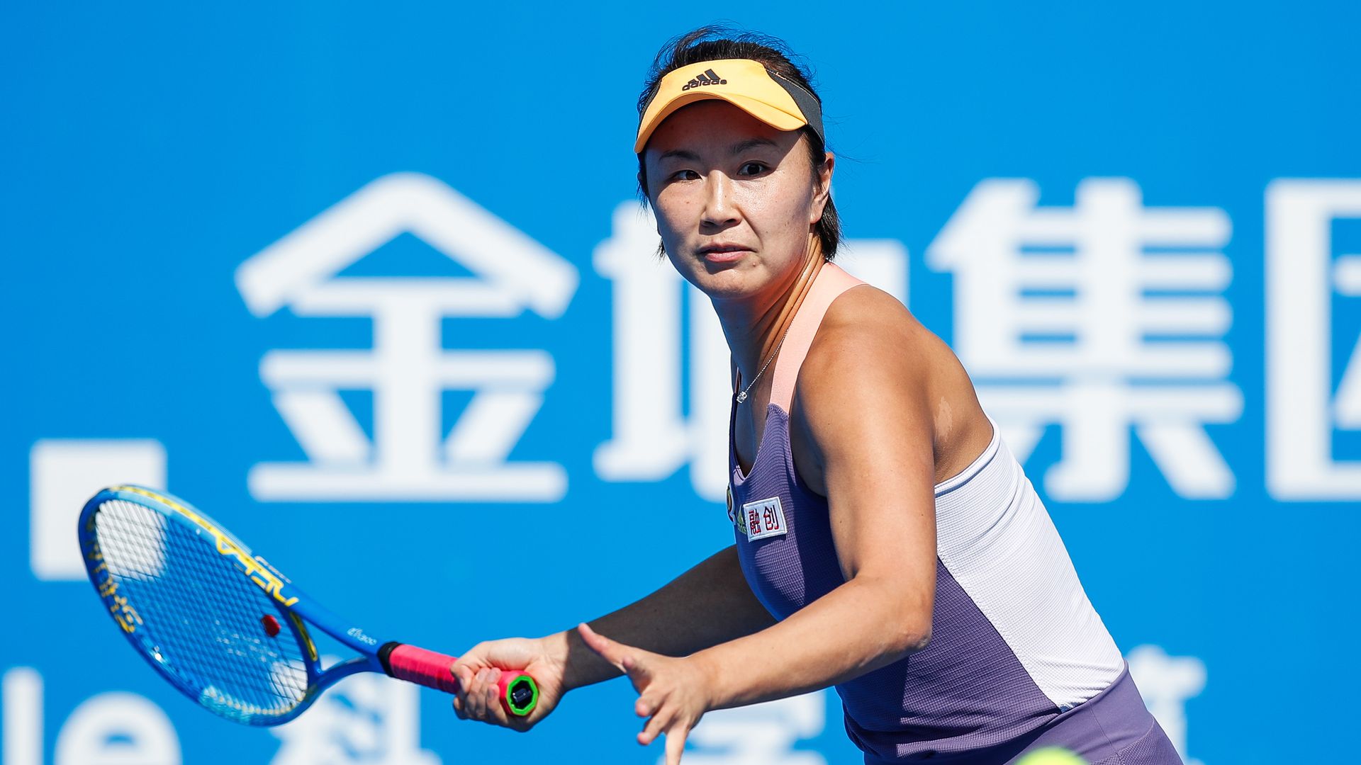 Photo of a tennis ball in the air as Peng Shuai raises her racket