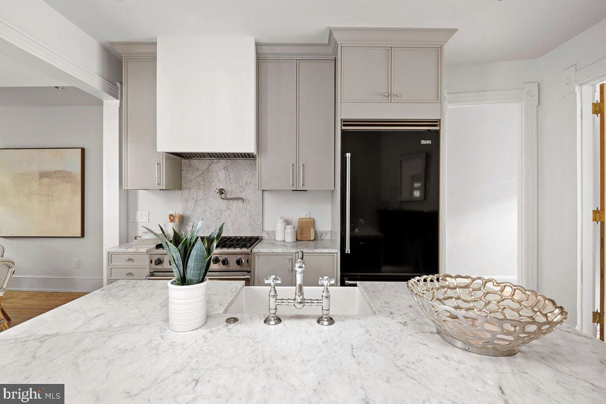 A kitchen with marble countertops.