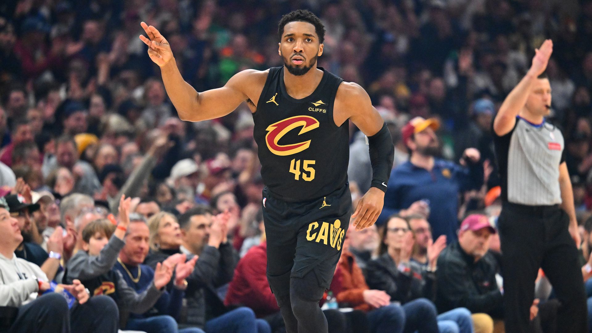 NBA player Donovan Mitchell in black jersey after making basket